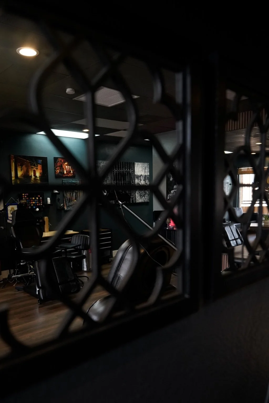 Black Nova’s artwork and tattoo stations seen through a decorative mirror