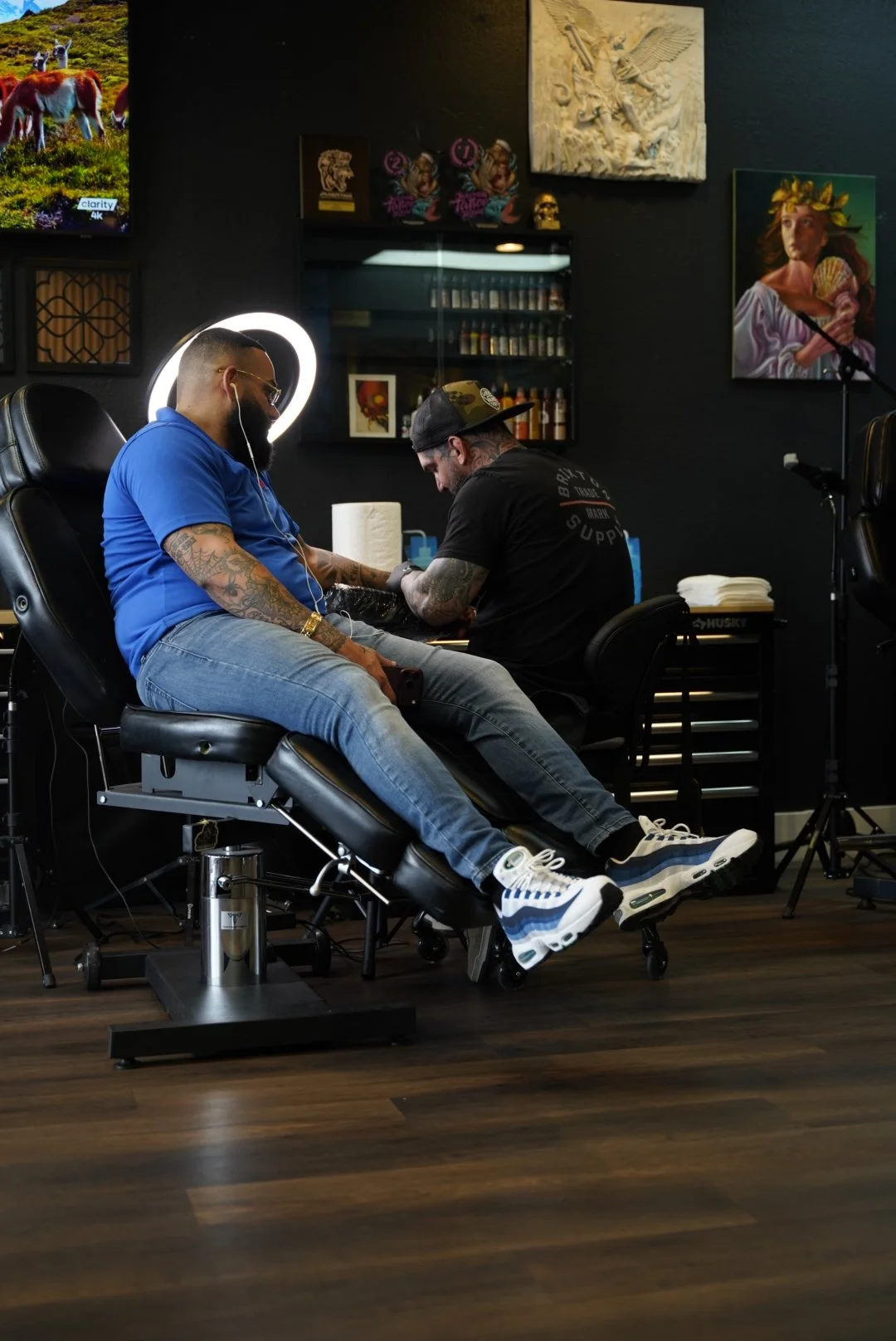 Tattoo artist working with a client at Black Nova Tattoo Collective