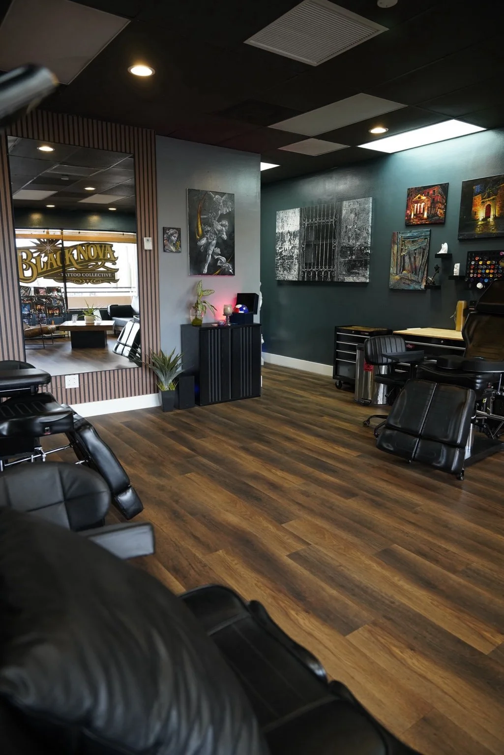 Tattoo artists working with clients inside Black Nova Tattoo Collective in Miami