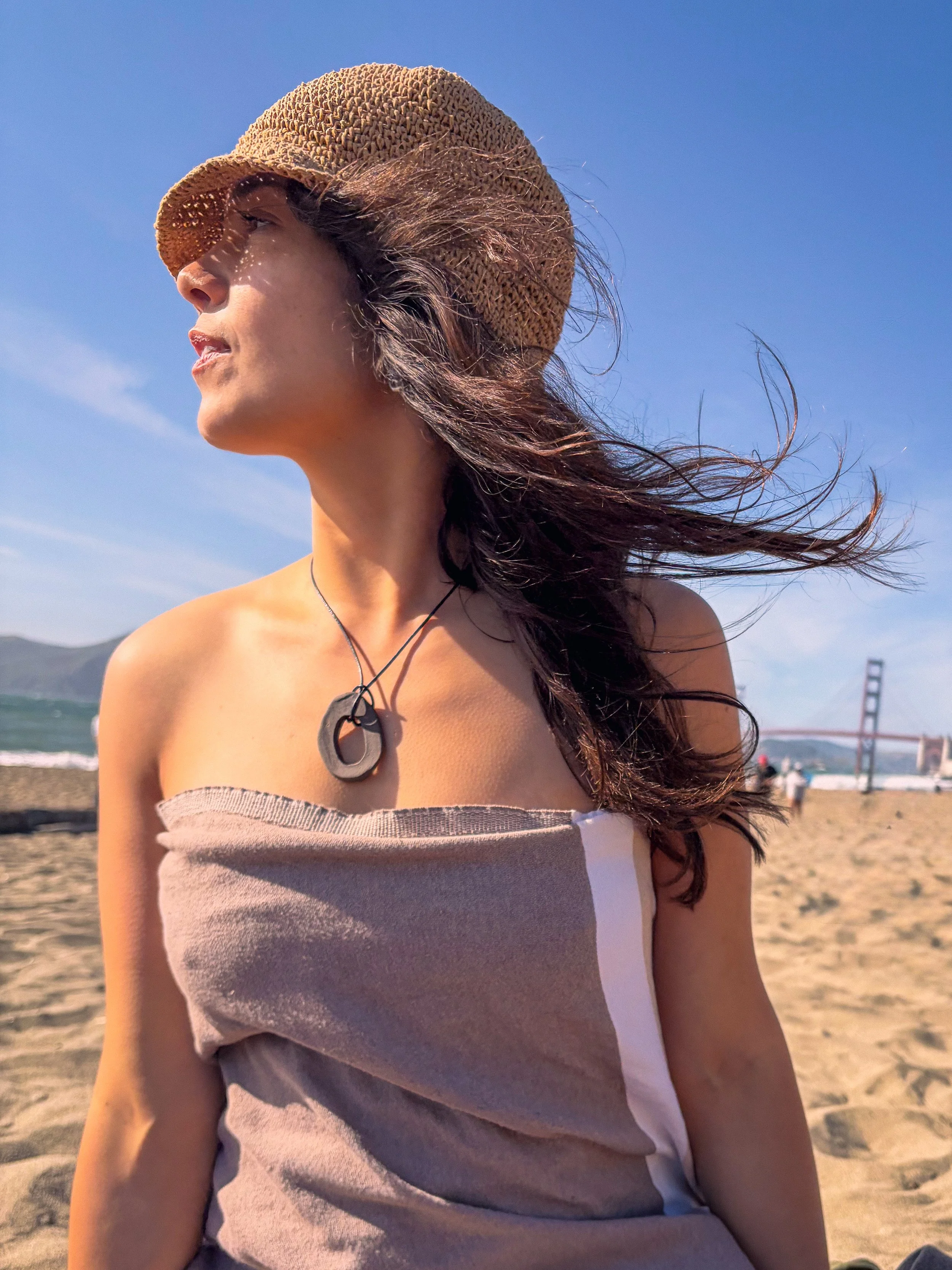 Jael wearing a red clay bead necklace