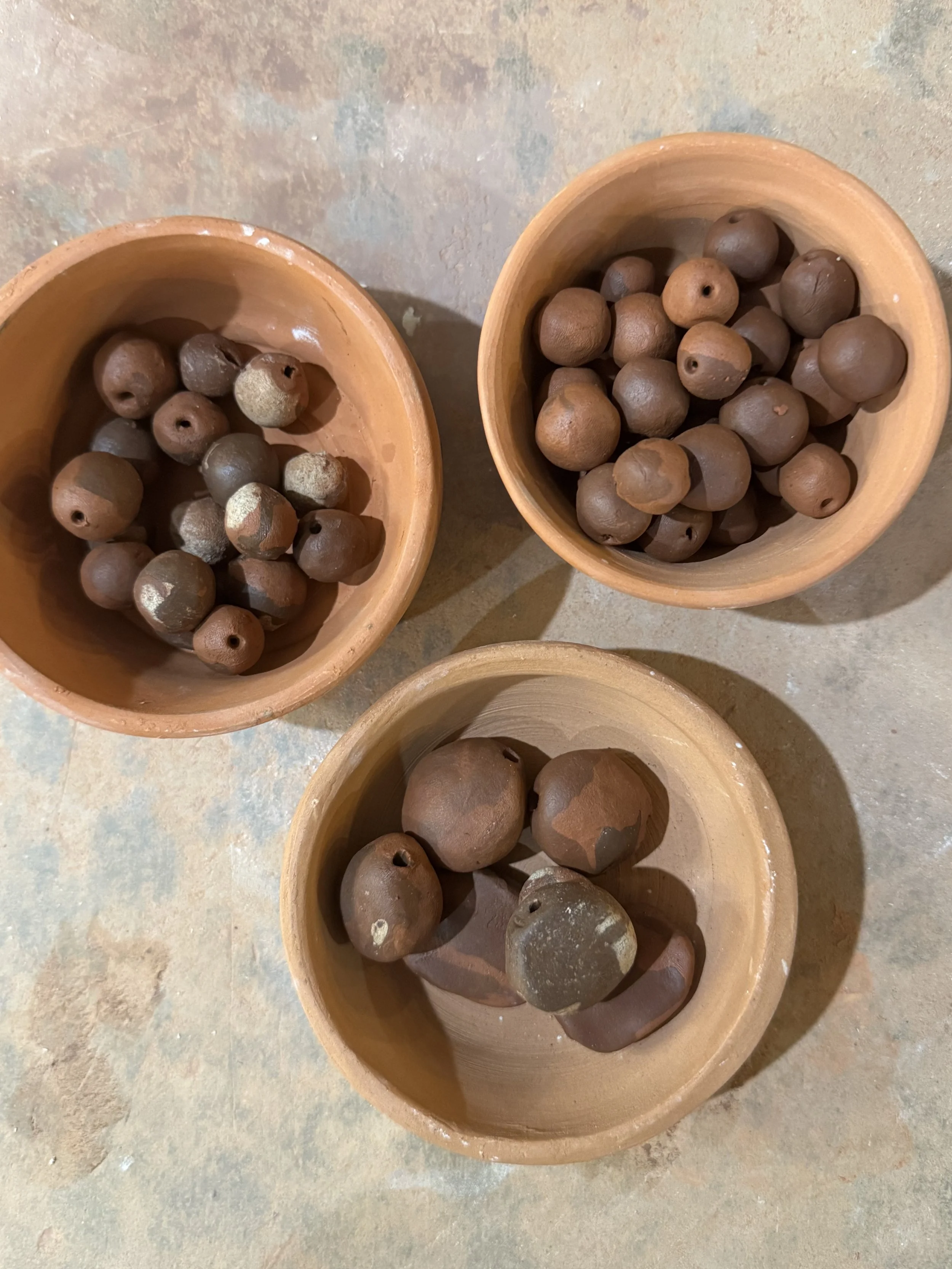 Bowls of handmade clay beads