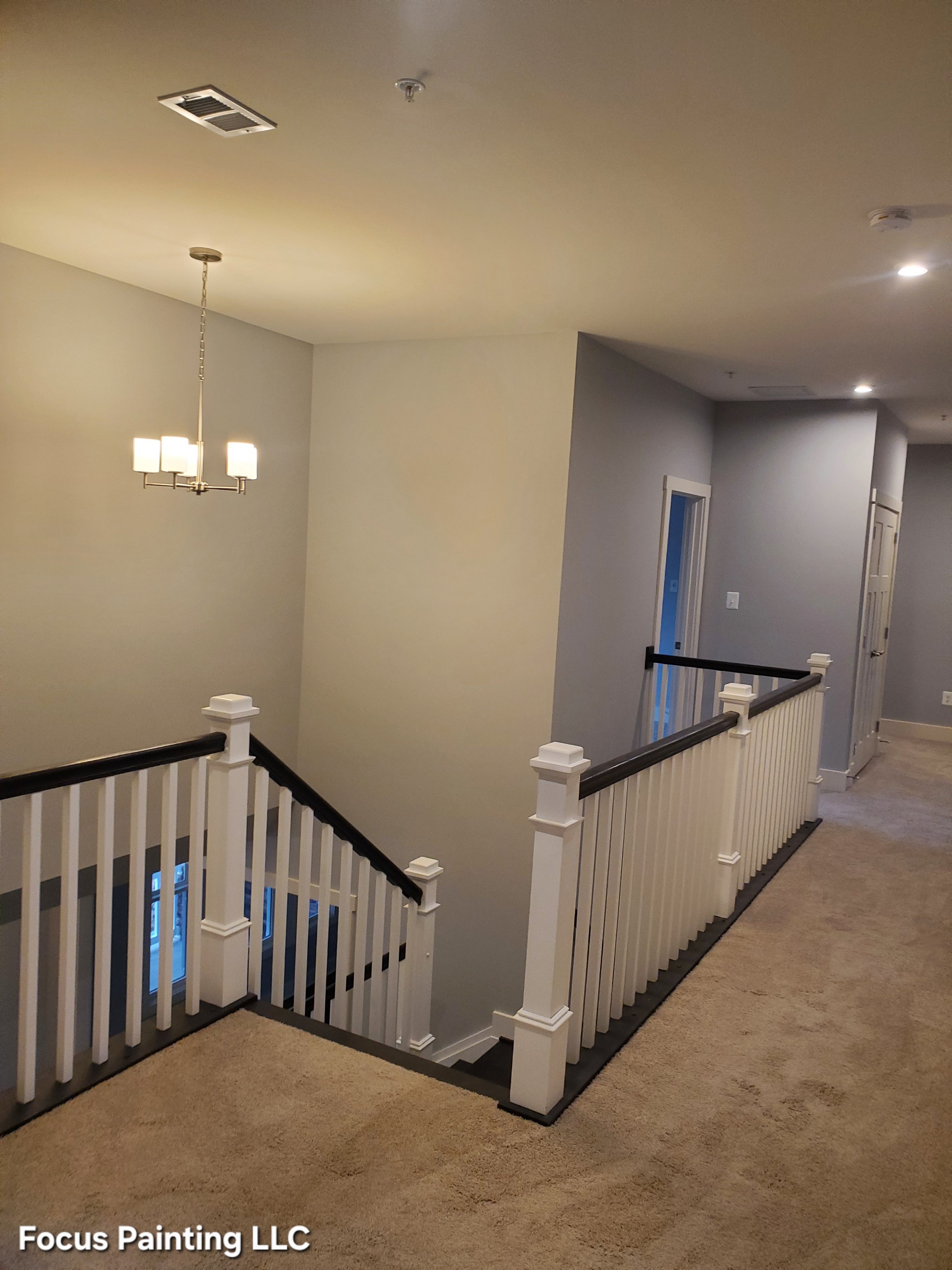Interior hallway ceiling, walls, and railings painted by Focus Painting in Maryland