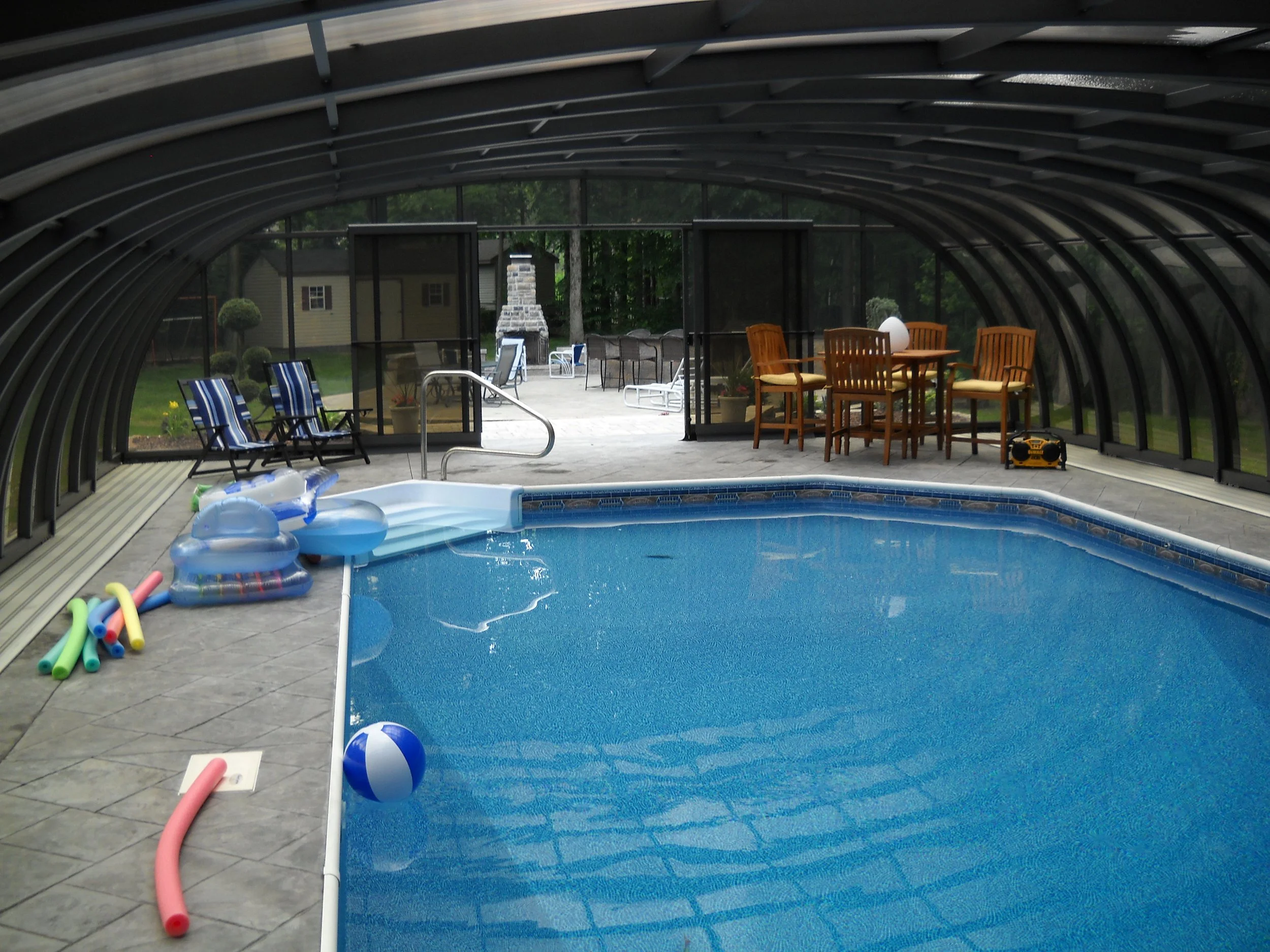 Laguna retractable pool enclosure installed over a backyard pool