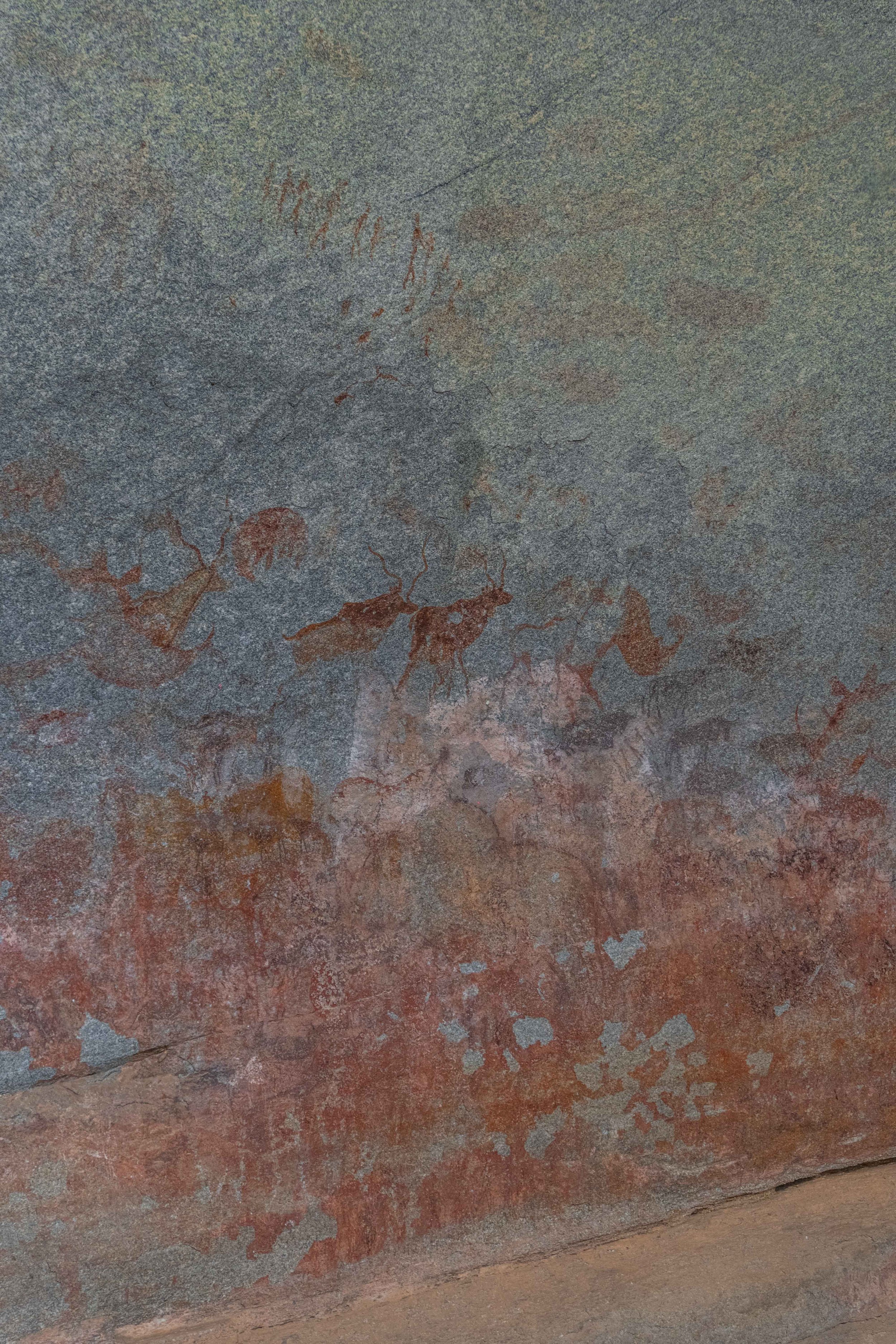 Line of human figures above animals