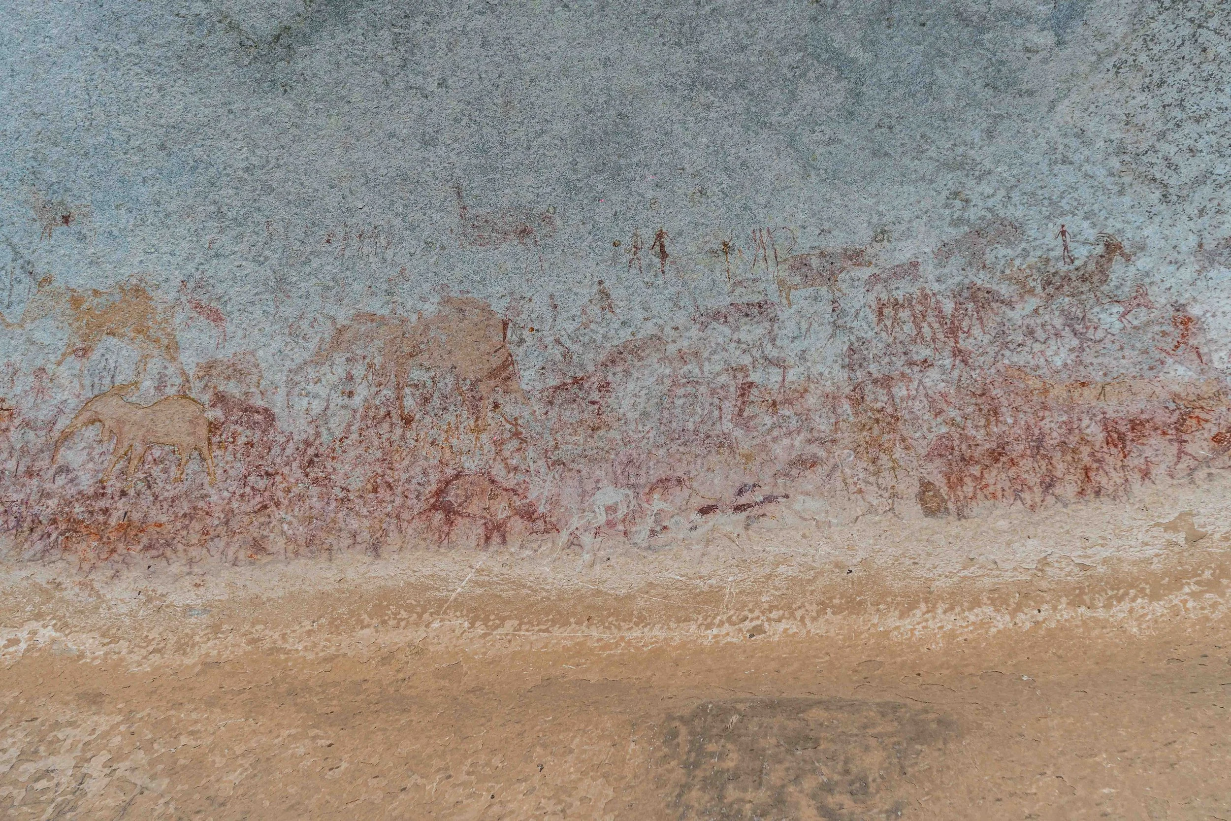 Line of human figures above animals