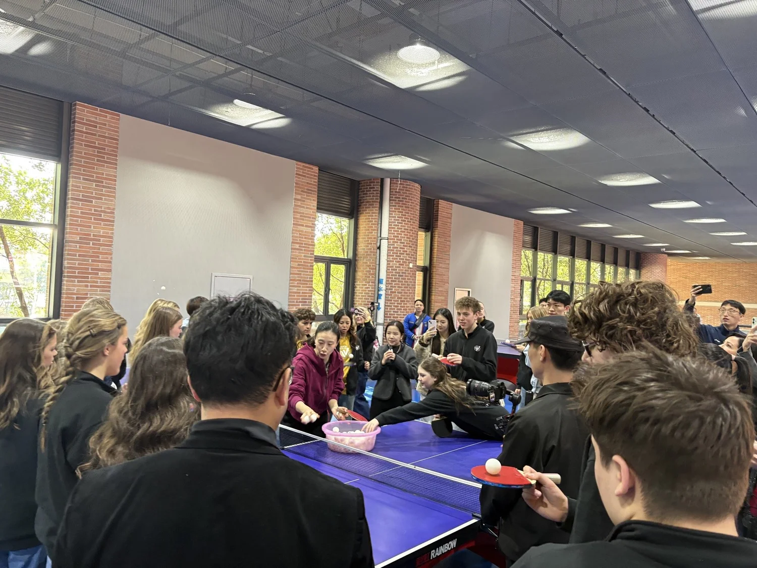 Friendly table tennis exchange in the campus athletic center.