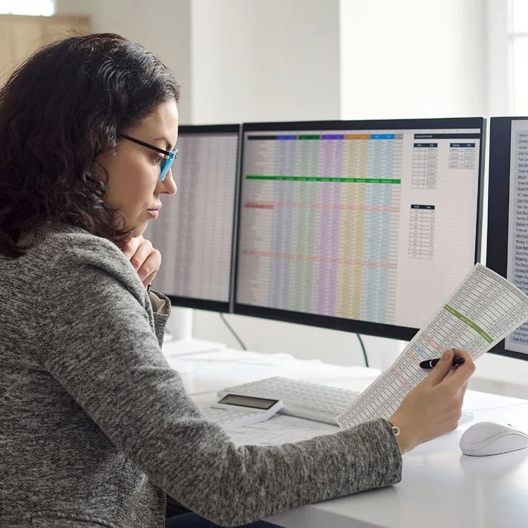 Finance manager reviewing figures at her desk
