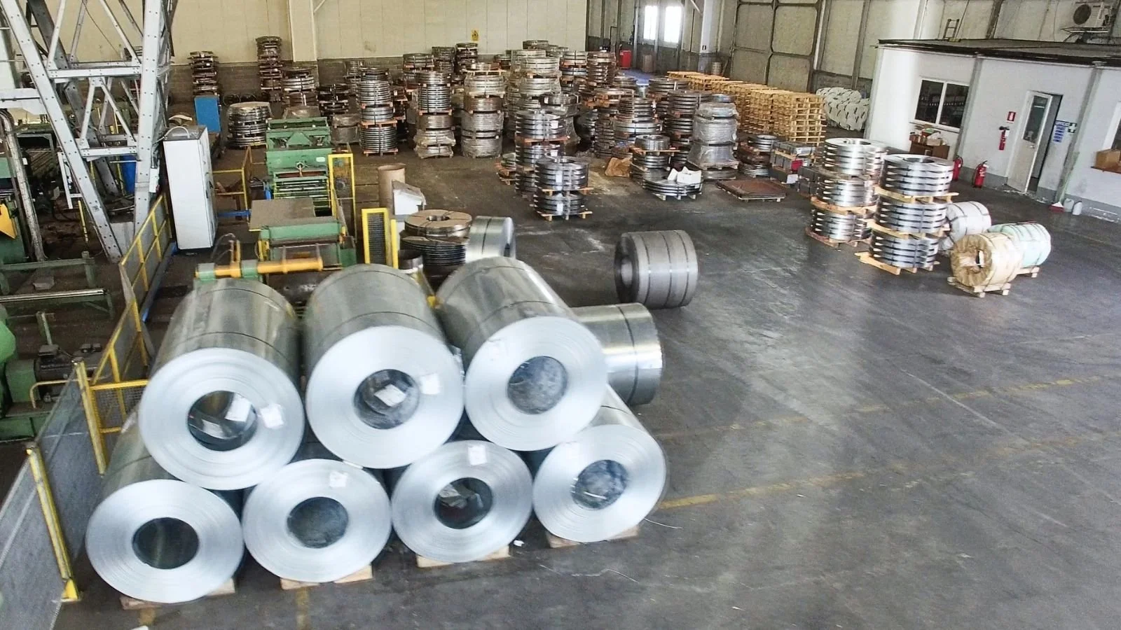 Imported steel coils stored on a warehouse floor awaiting release