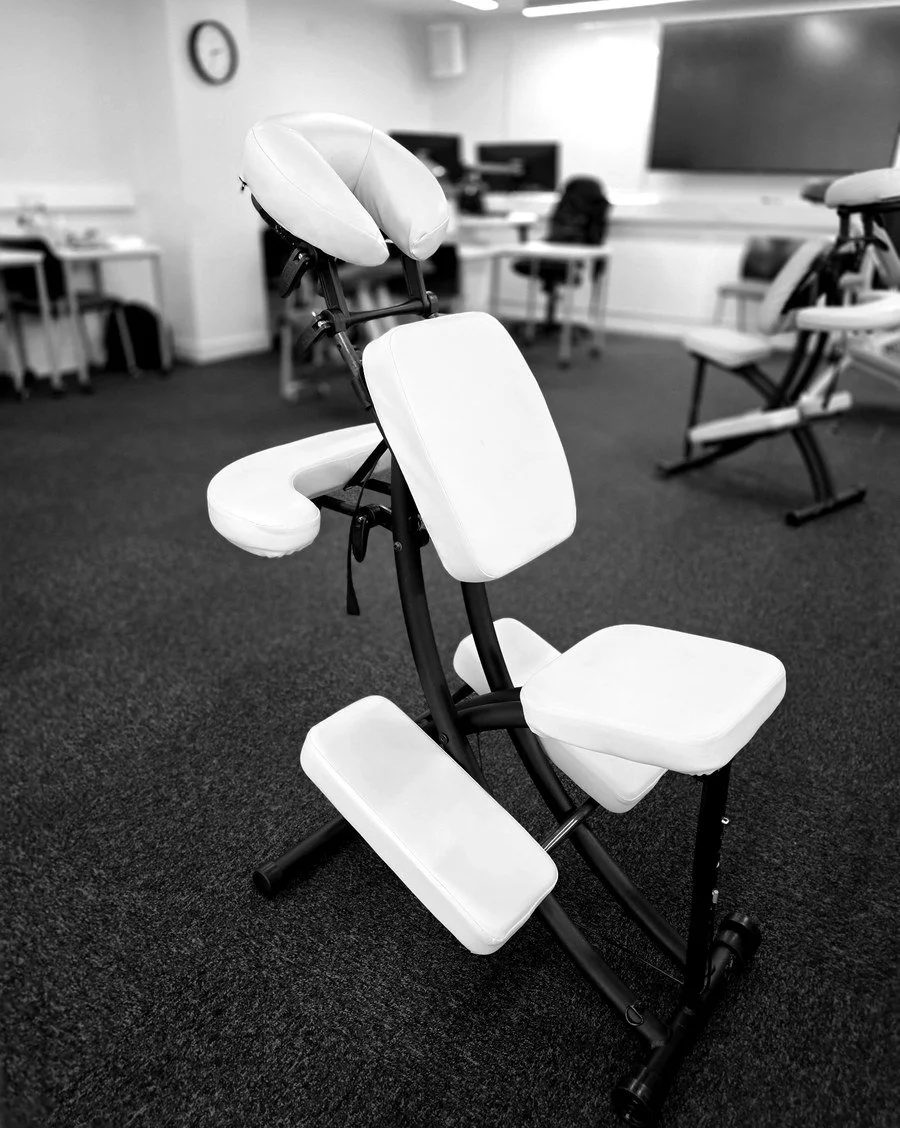 Massage chairs set up in a workroom, ready for an on-site session