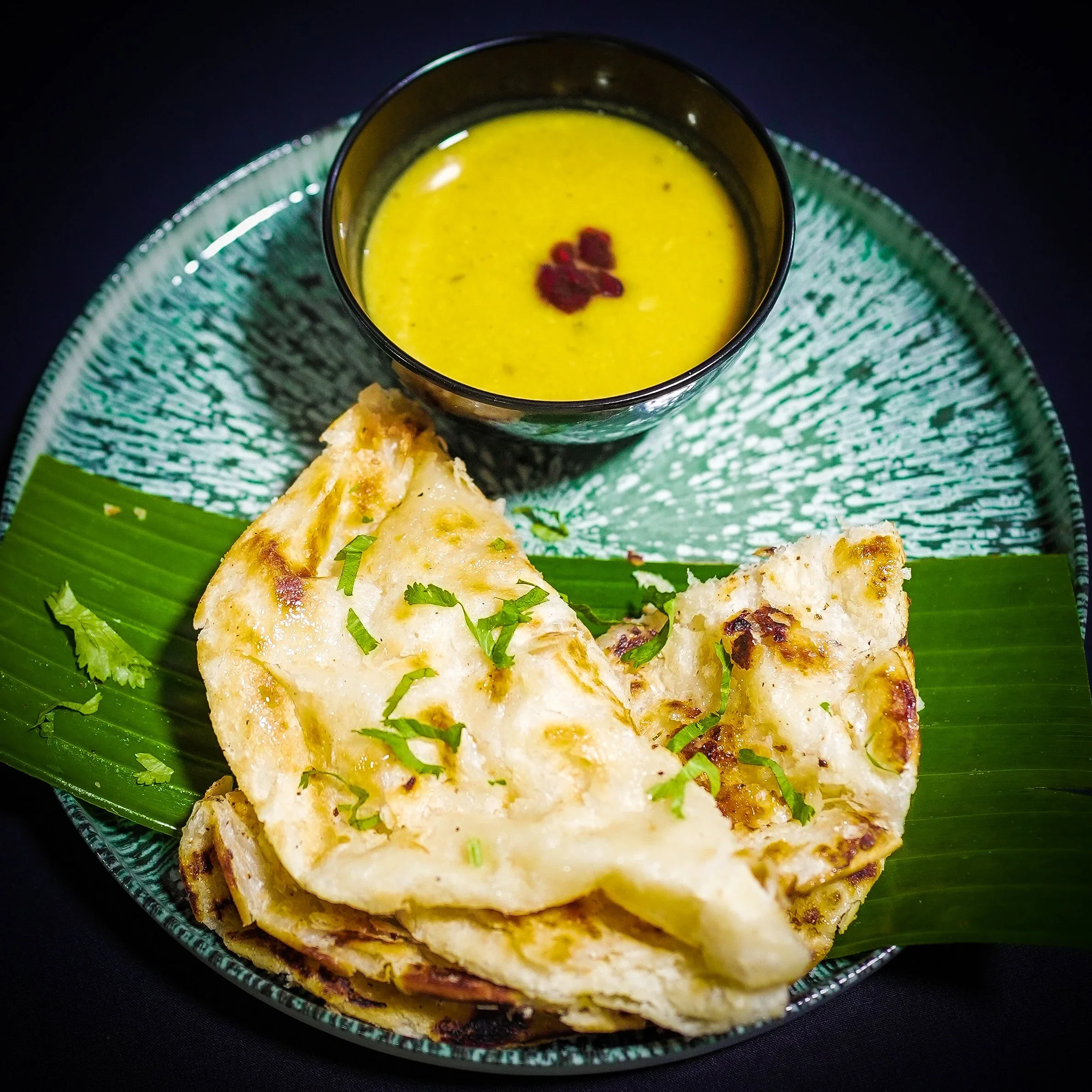 Roti canai served with curry at The Malay Courtyard