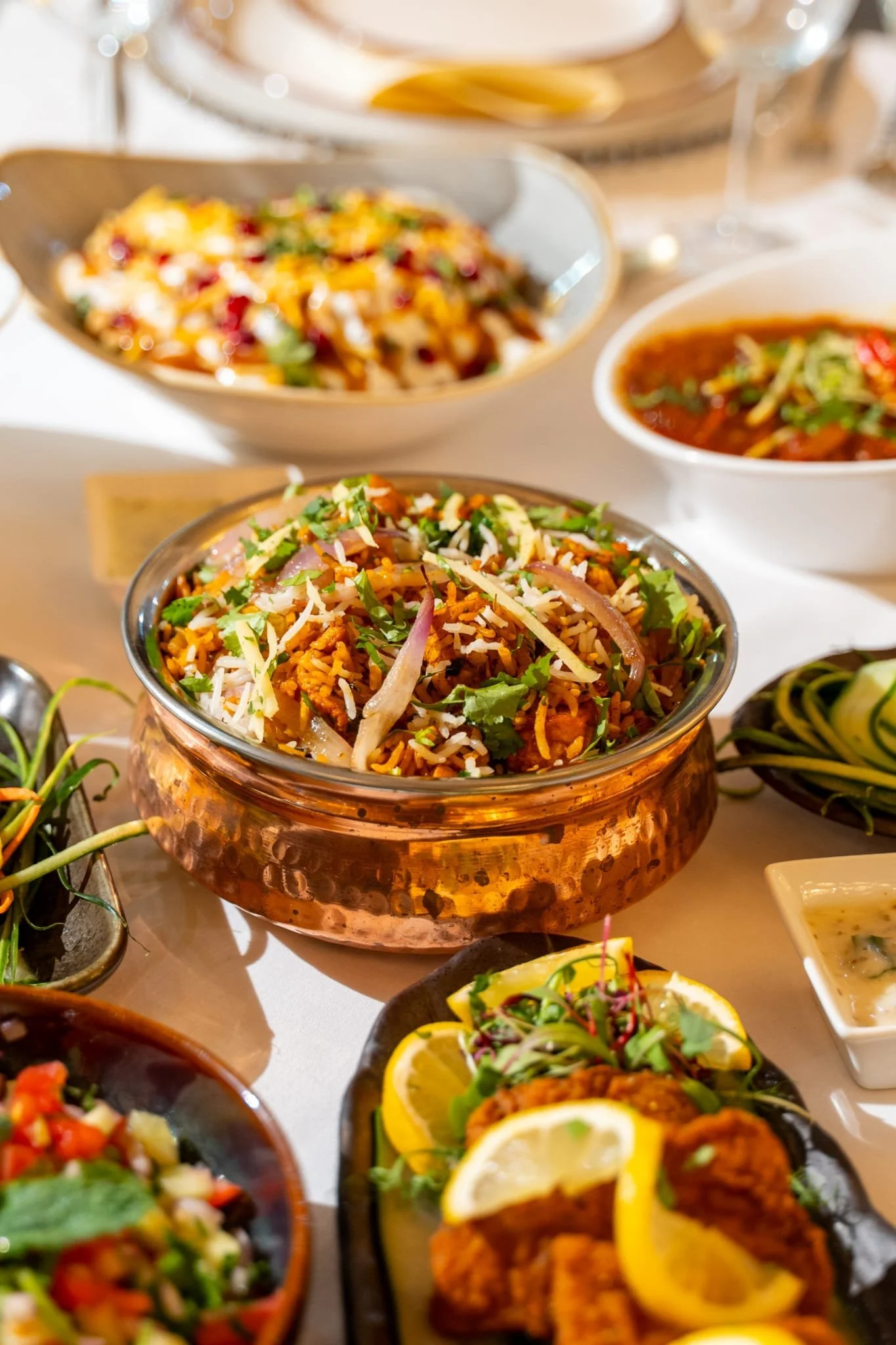 Pakistani rice and curry dishes presented in serving bowls