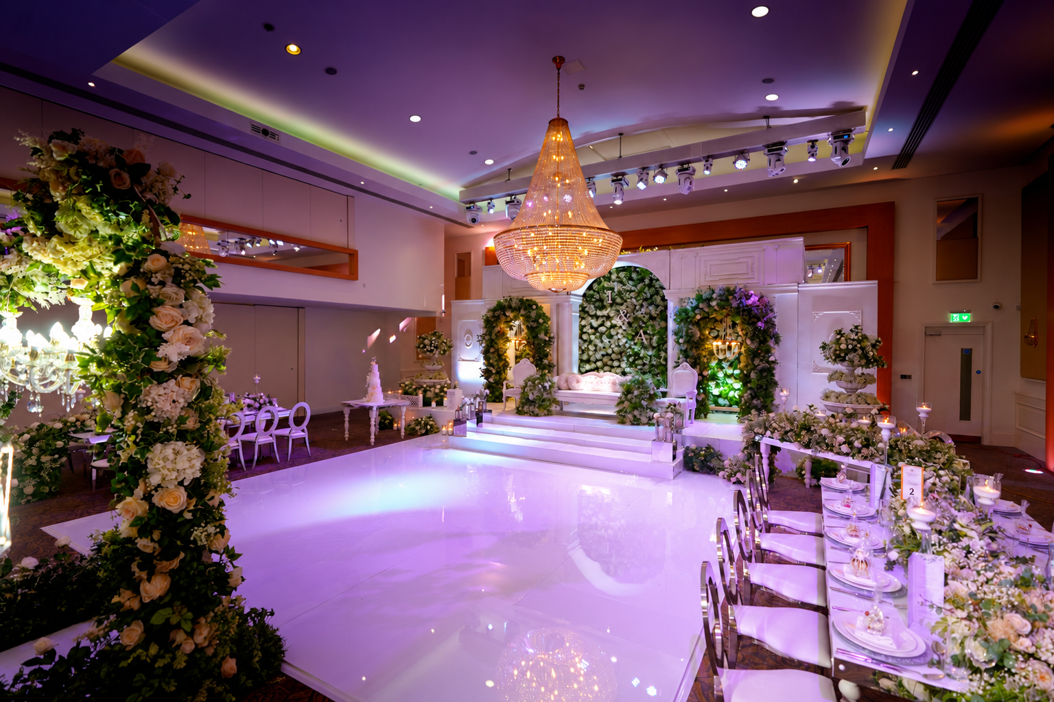 White reception stage and dance floor under purple lighting