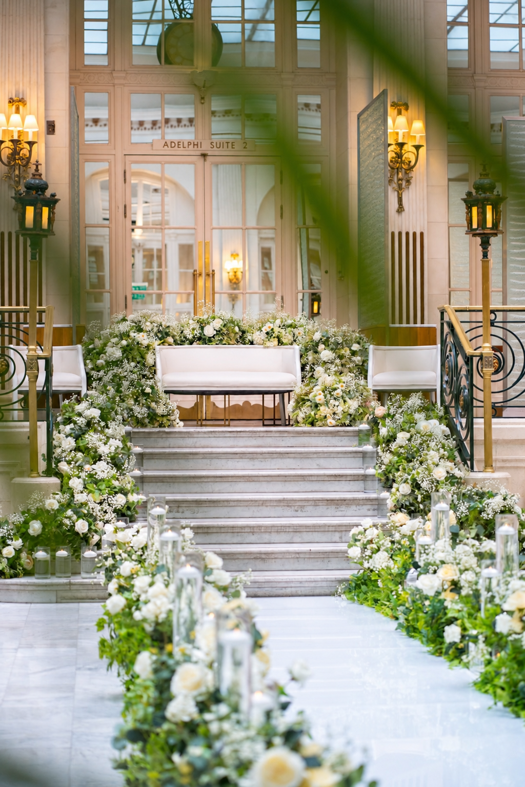 A floral ceremony entrance with a white staircase