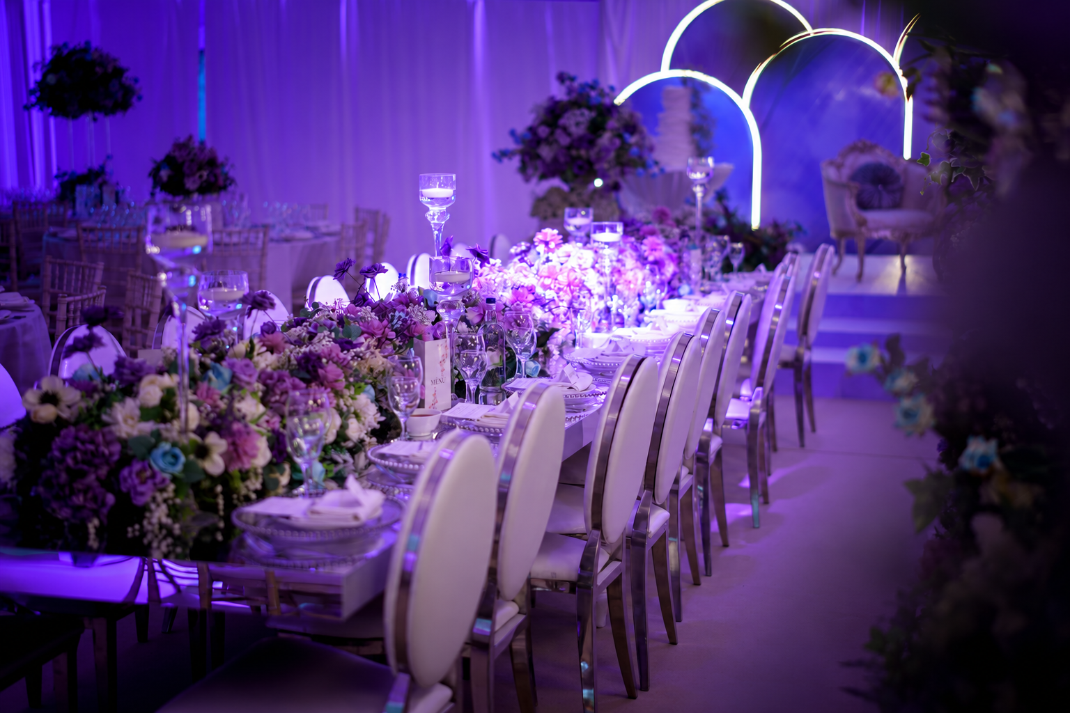 Long reception tables dressed with flowers and candles