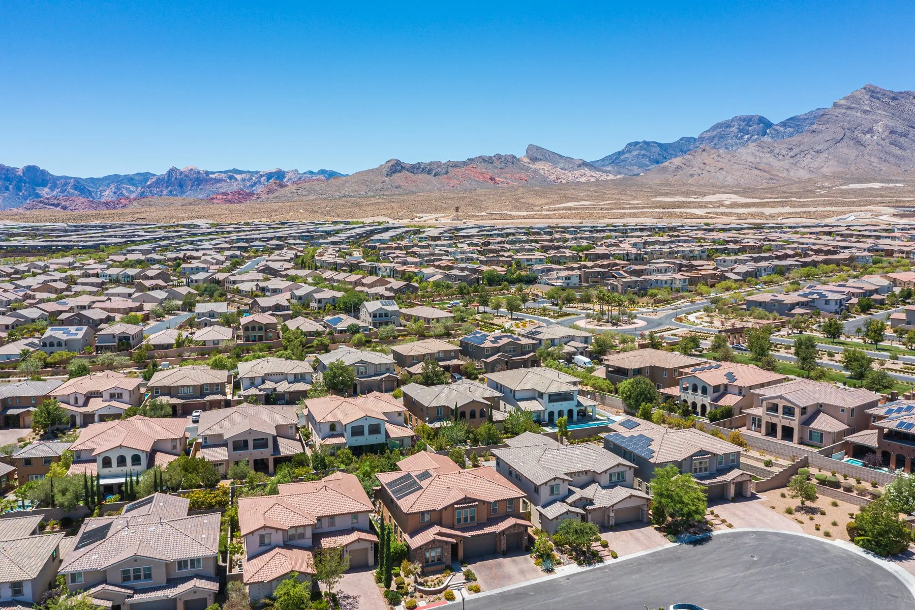 Aerial view of Summerlin West in Las Vegas with the Red Rock escarpment and mountain range on the horizon
