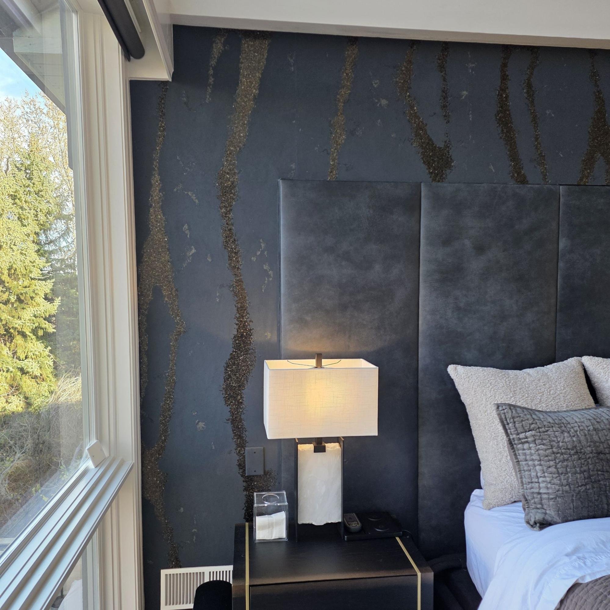 Completed Phillip Jeffries accent wall behind a bed in a Boulder primary bedroom.