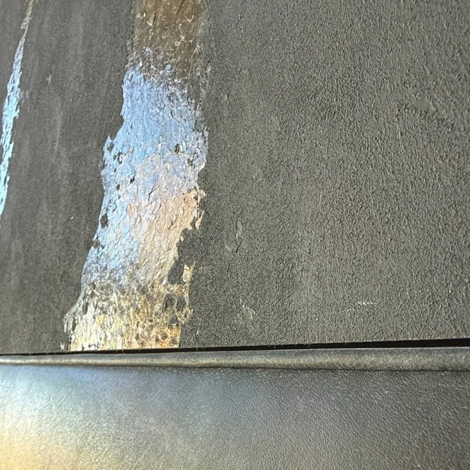 Close view of the gold-toned decorative detail in the Phillip Jeffries wallcovering.