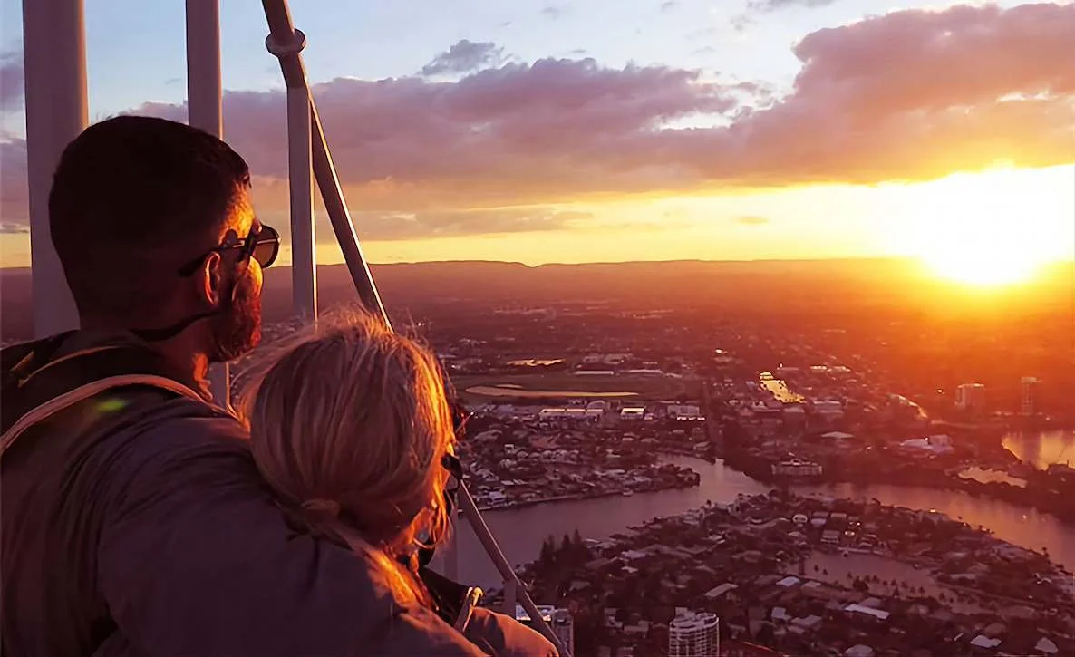 Guests watching sunrise over the Gold Coast from a hot air balloon