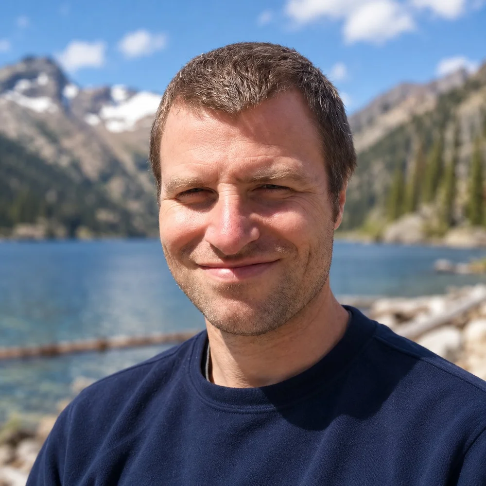 Paul Walsh, LMFT, smiling outdoors beside a mountain lake in the Pacific Northwest
