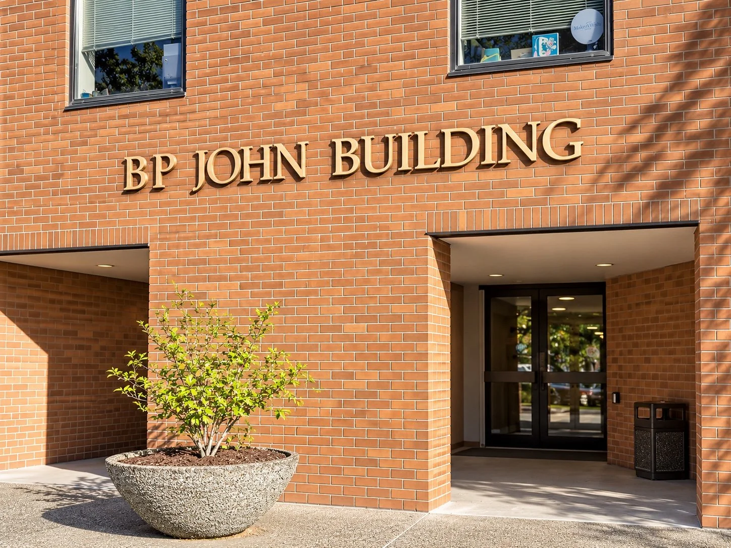Main entrance of the BP John Building at 5901 S Macadam Ave in Johns Landing, Portland, where Quiet Light Counseling is in Suite 100