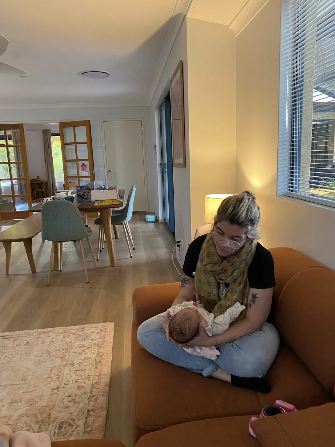 A relaxed postnatal home visit with a parent and baby