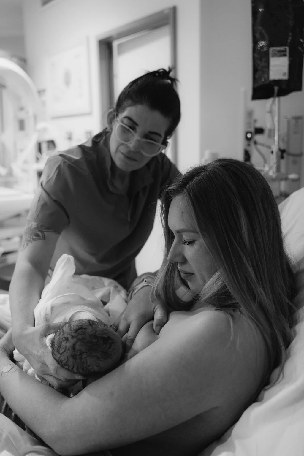Emma supporting a mother and newborn in the first moments after birth