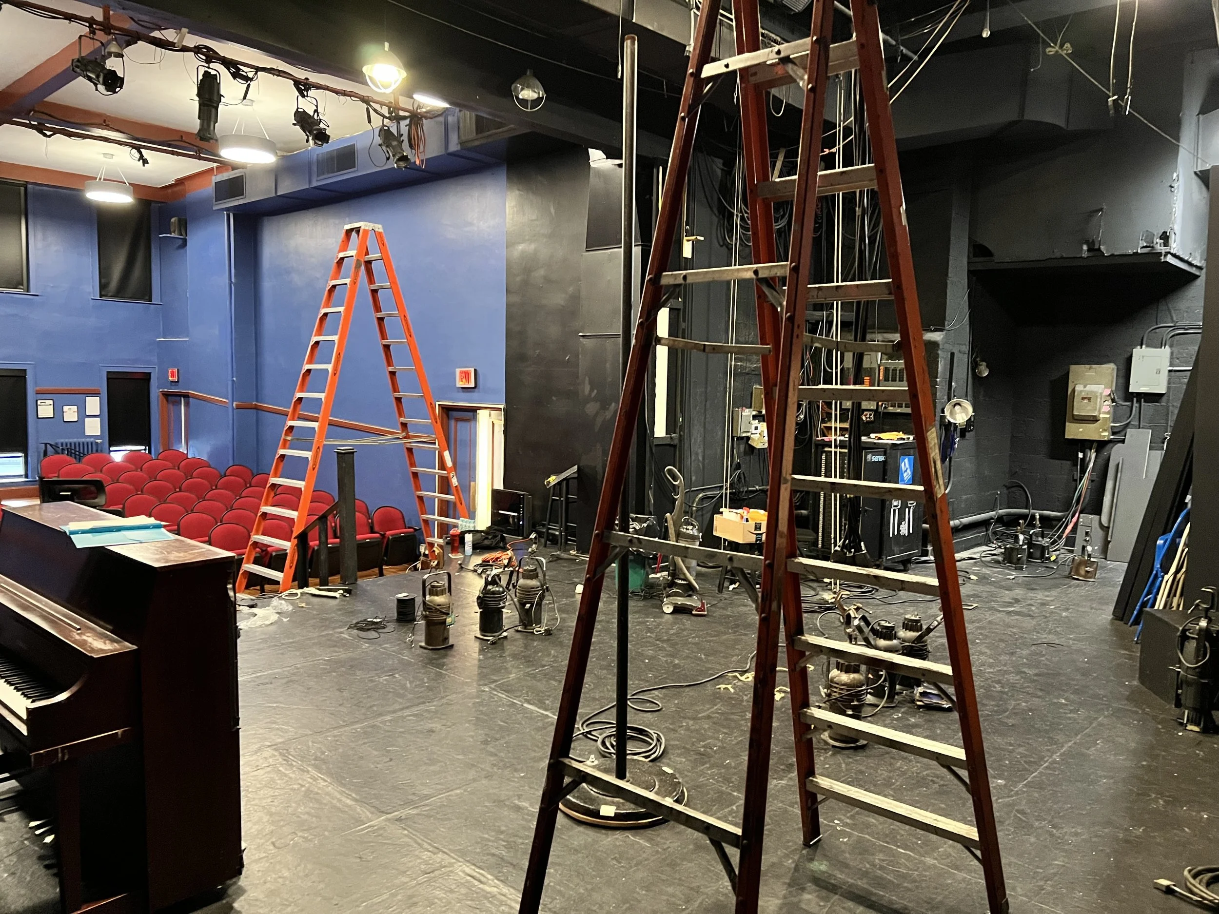 Ladders and stage lighting equipment during production load-in