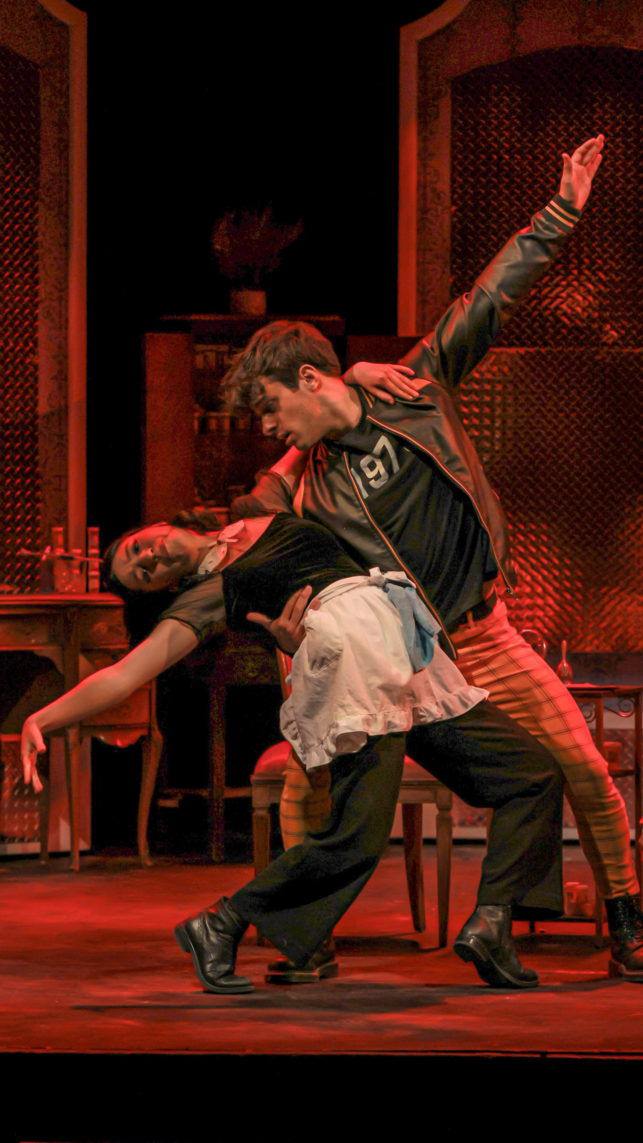 Two performers grapple in a comic physical scene from Molière’s The Imaginary Invalid.