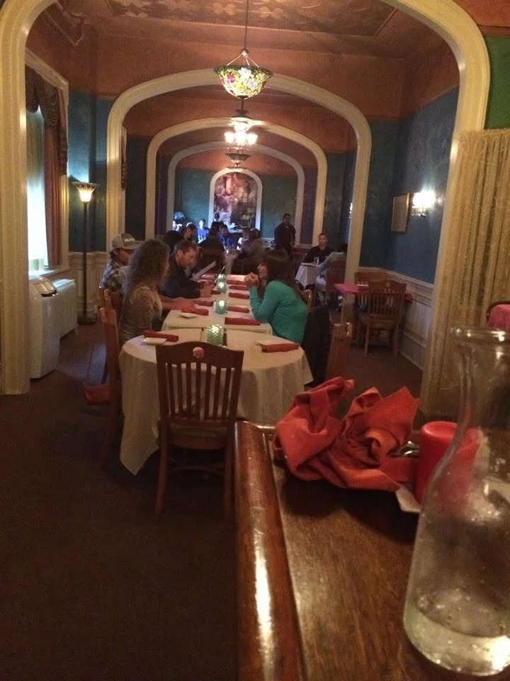 Guests seated at dining tables beneath the arched ceiling at Ka-bobs at The Option House.
