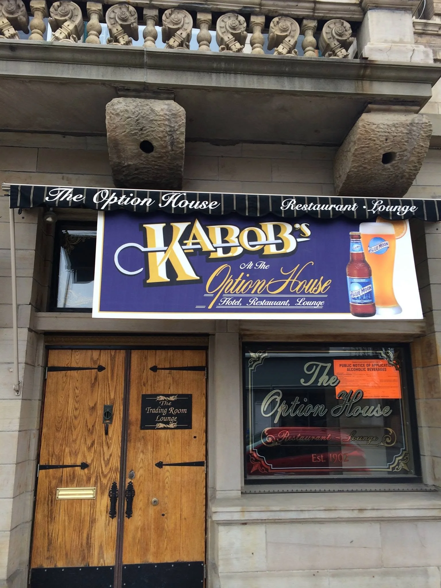 Entrance to The Option House with the Ka-bobs sign above the wooden doorway.
