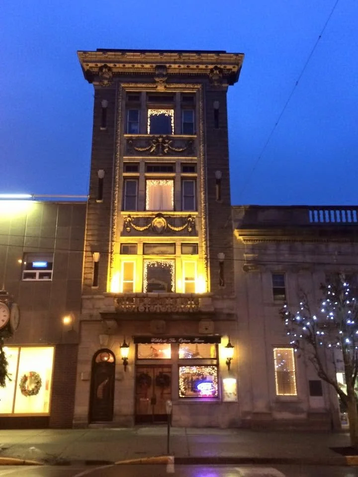 The full illuminated Option House building at dusk, from its rooftop to Main Street in Bradford, Pennsylvania