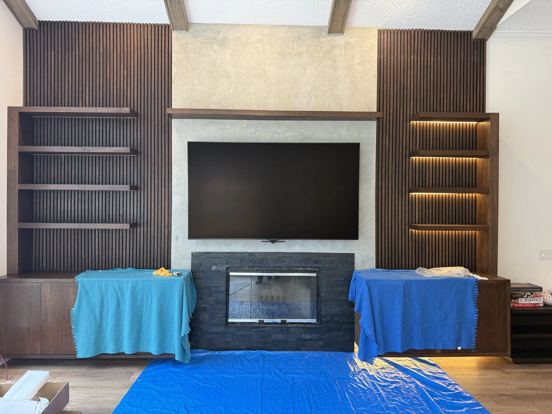 Installed media wall with display, shelving and integrated lighting