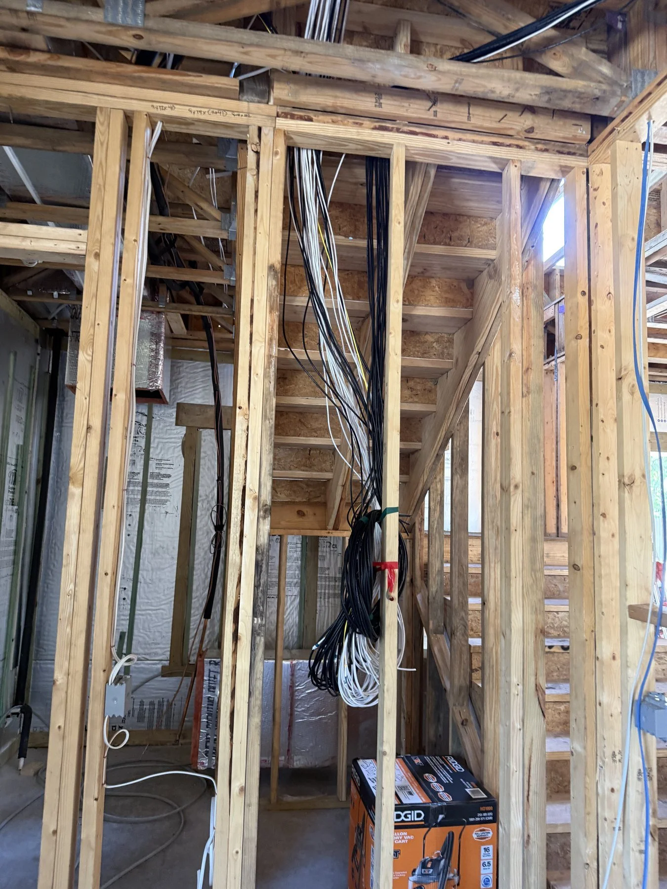 Prewire stage: grouped cable home runs within the framing.