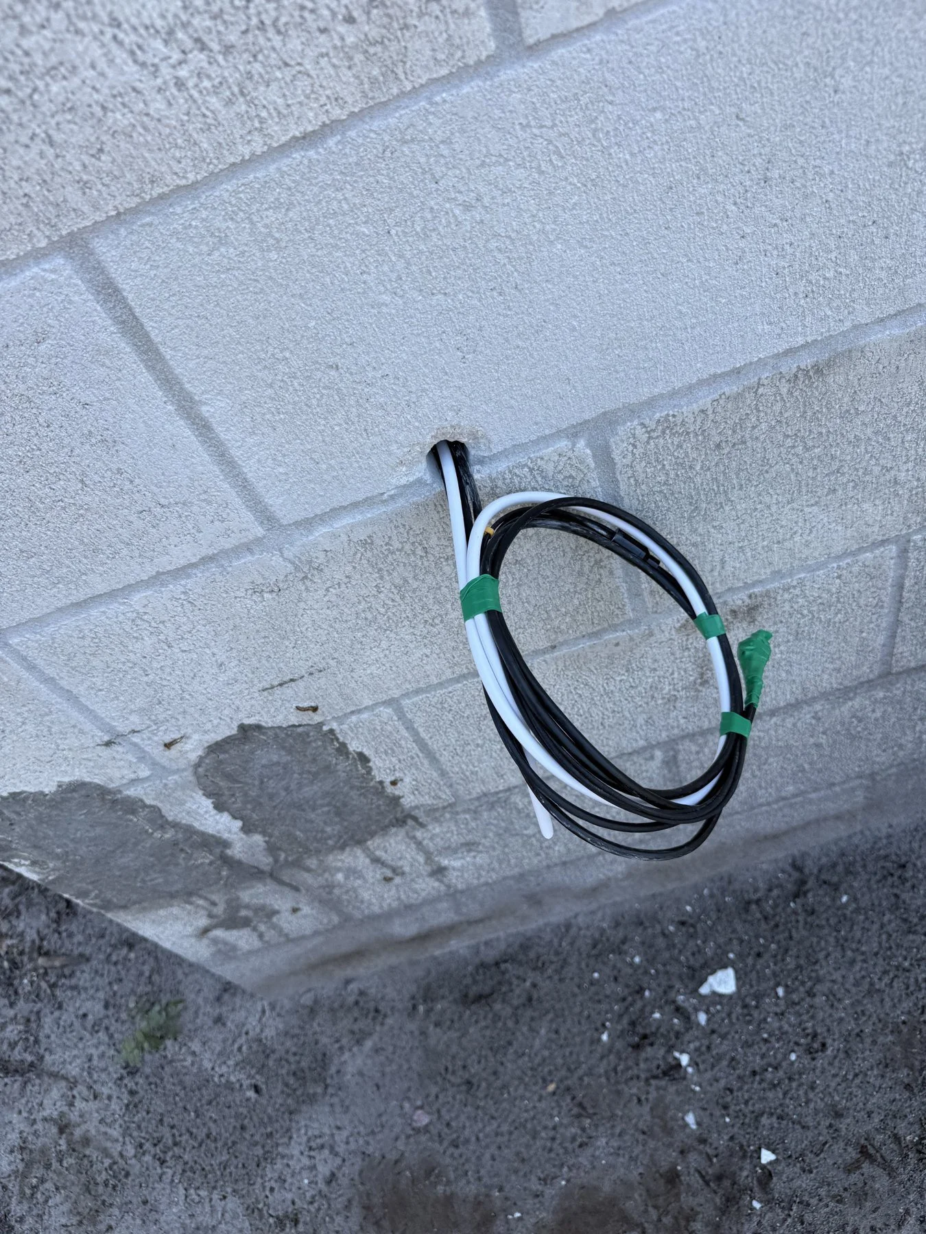 Prewire stage: cable route prepared at an exterior connection location.