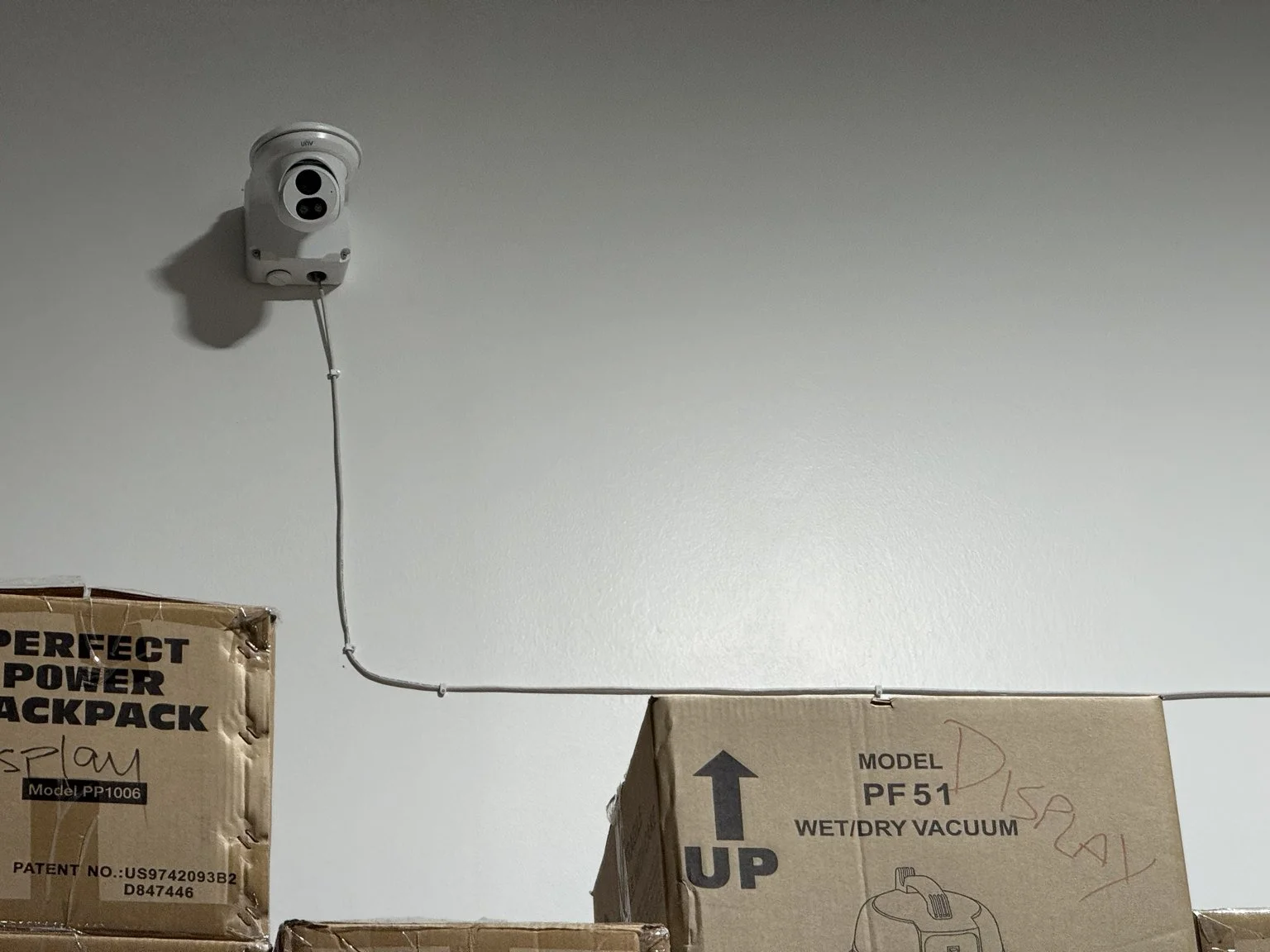 Installed Uniview security camera and mounting hardware in a commercial facility
