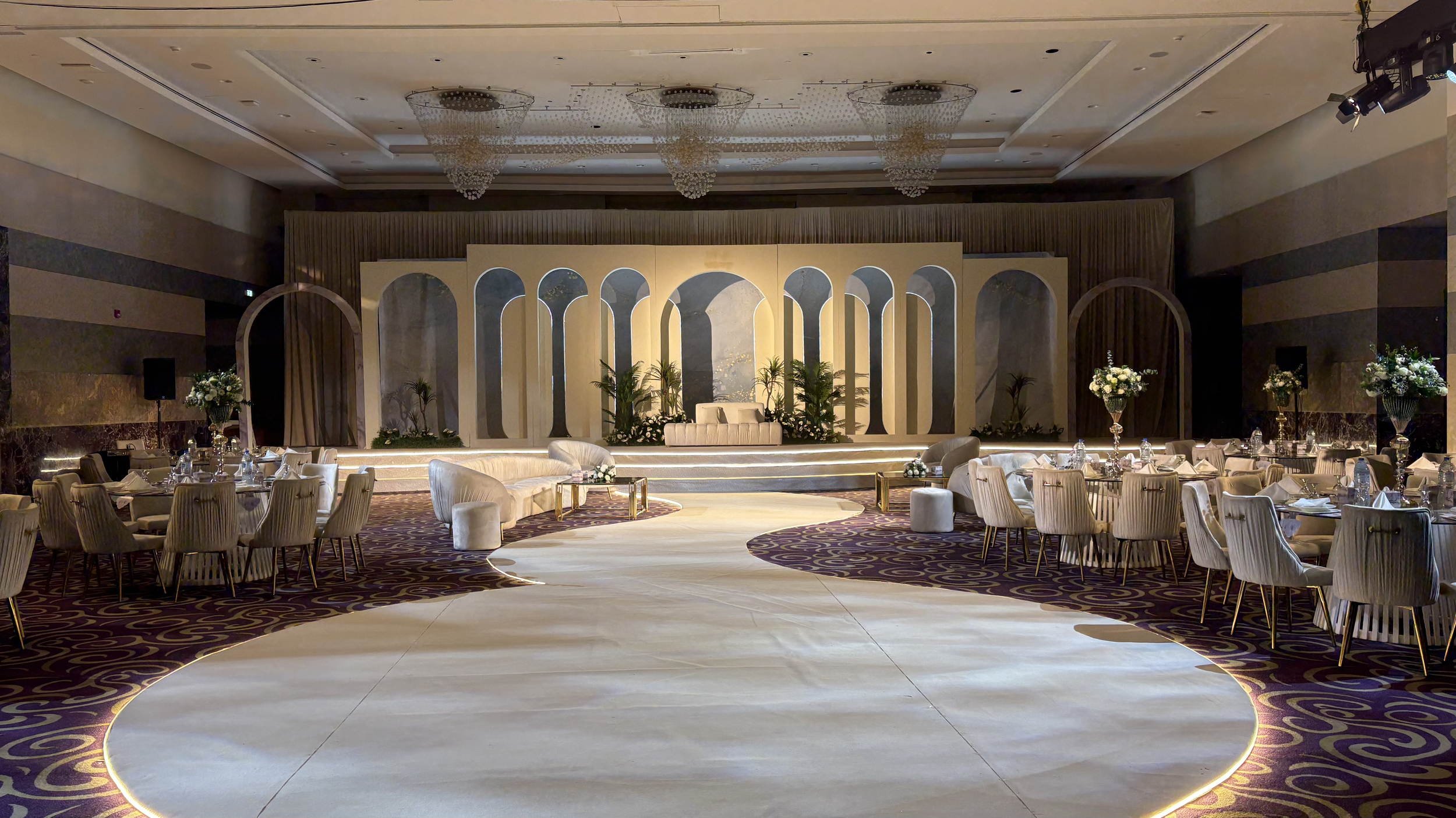 Nikkah ceremony lighting UAE — warm gold wash and soft beam atmosphere in hotel ballroom