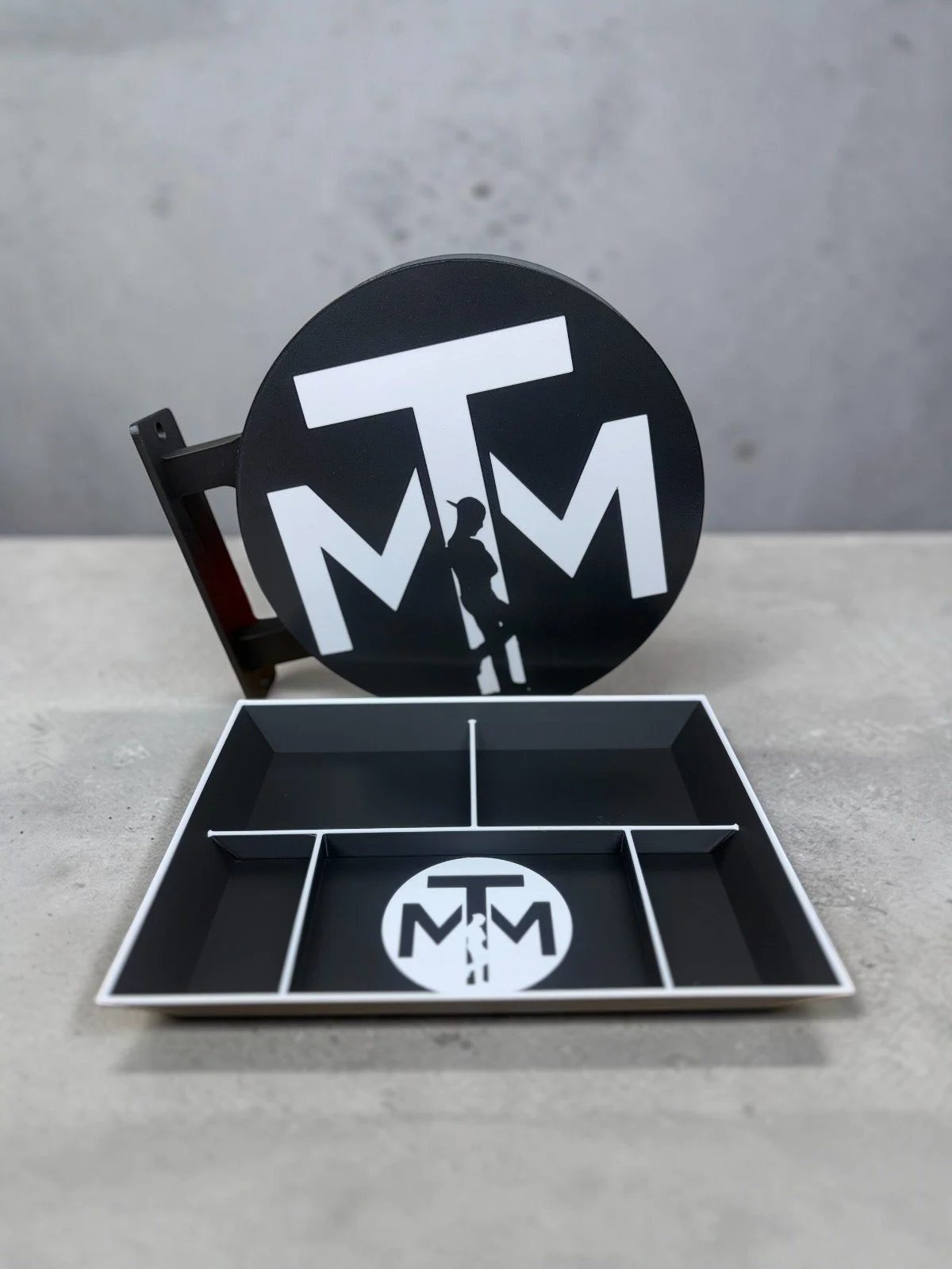 Custom 3D printed TMM branded valet tray with a matching round standing shop sign