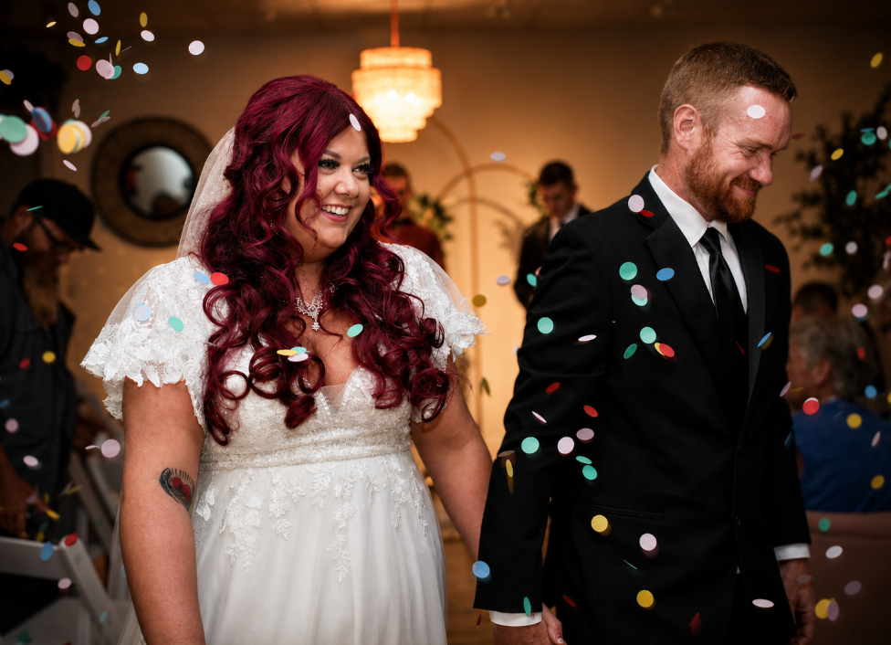 A newlywed couple celebrating at St. Croix Vow House as colorful confetti falls