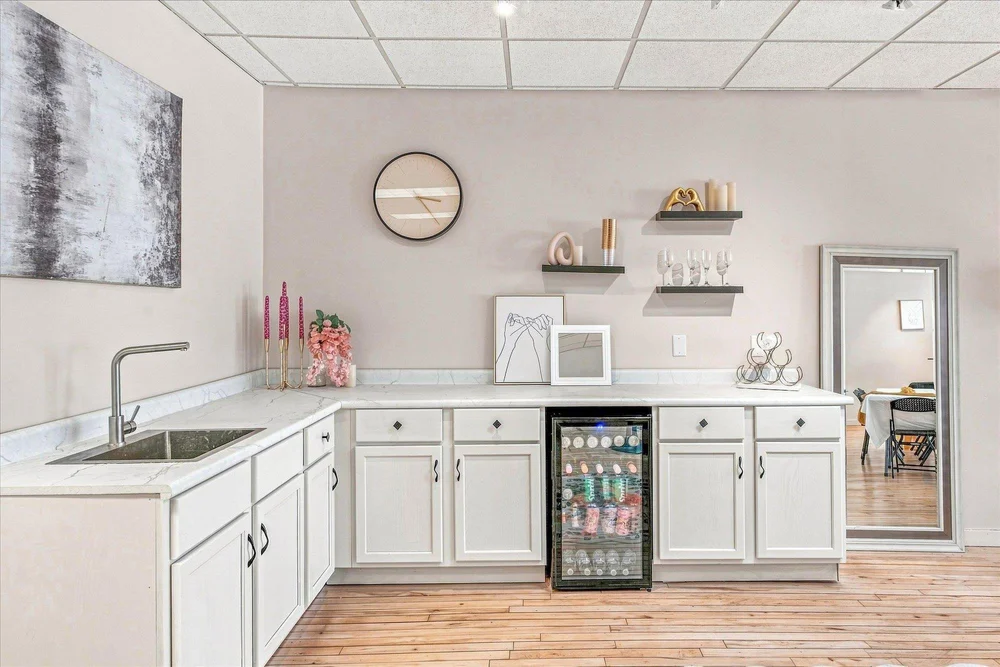 The venue’s wet bar with a sink, counter space, and beverage refrigerator