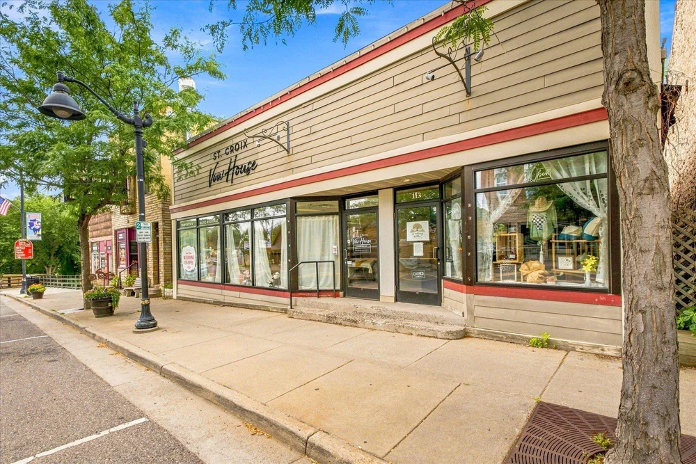 St. Croix Vow House storefront on a tree-lined street in downtown Osceola, Wisconsin