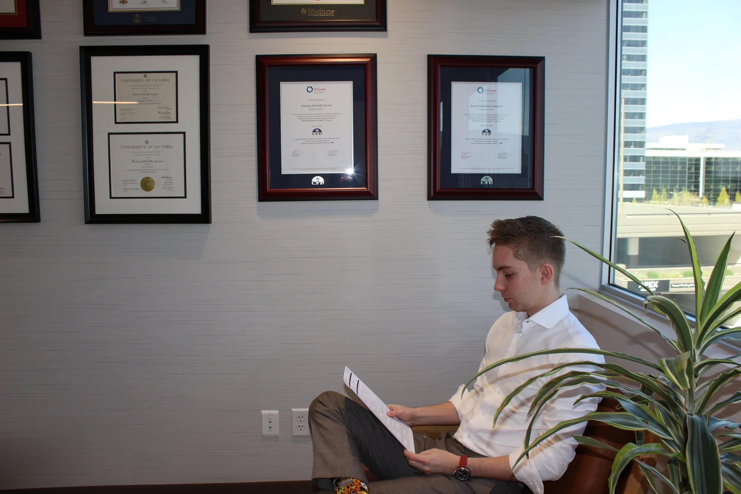 Bryan Cresswell, financial planner, in office with credentials on wall