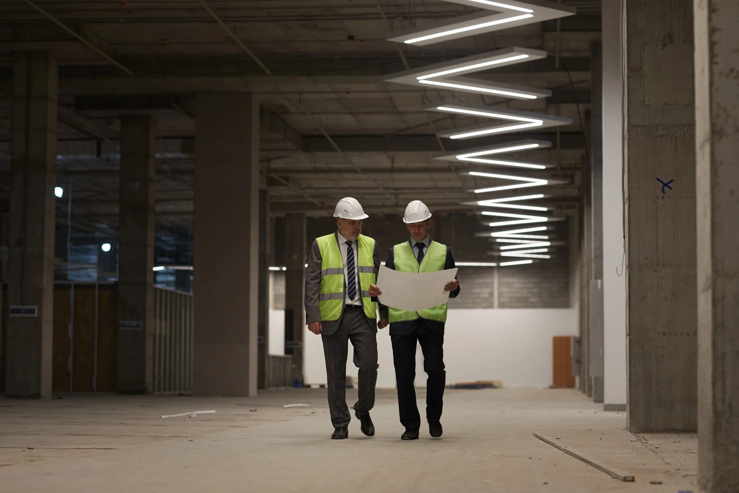Commercial construction — open floor space with workers