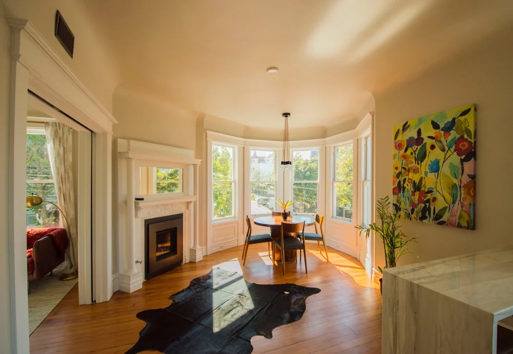 Renovated living and dining room with bay windows