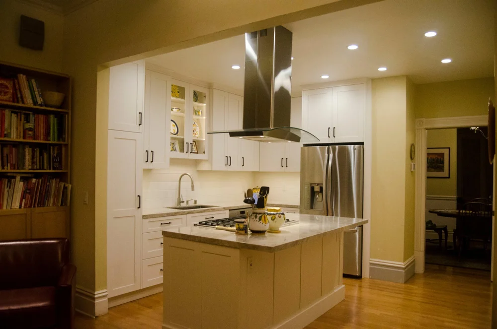 Remodeled kitchen with white cabinets and island