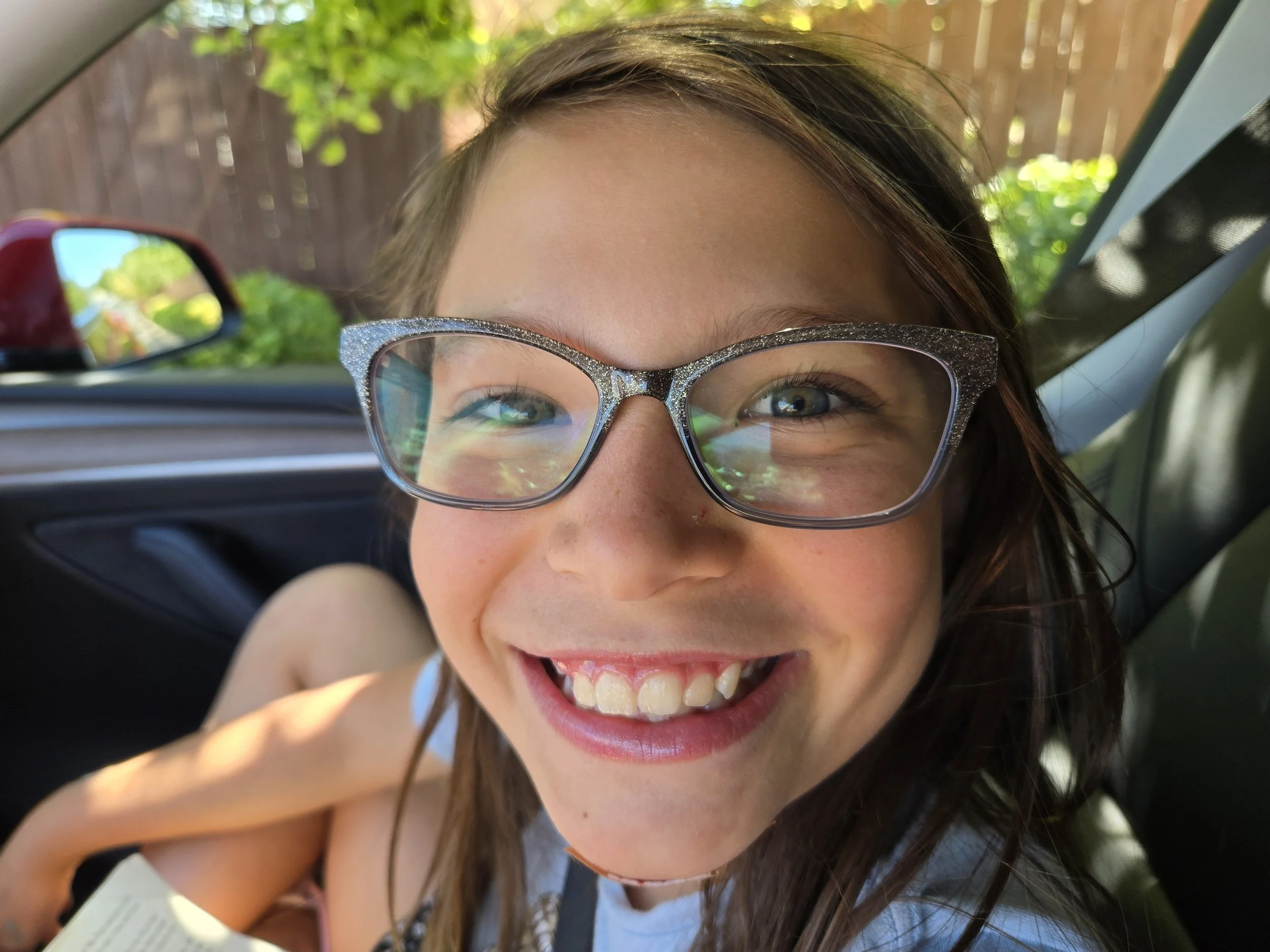 Girl smiling in car - pediatric PTSD and trauma therapy Good Day Mental Health Ogden Utah
