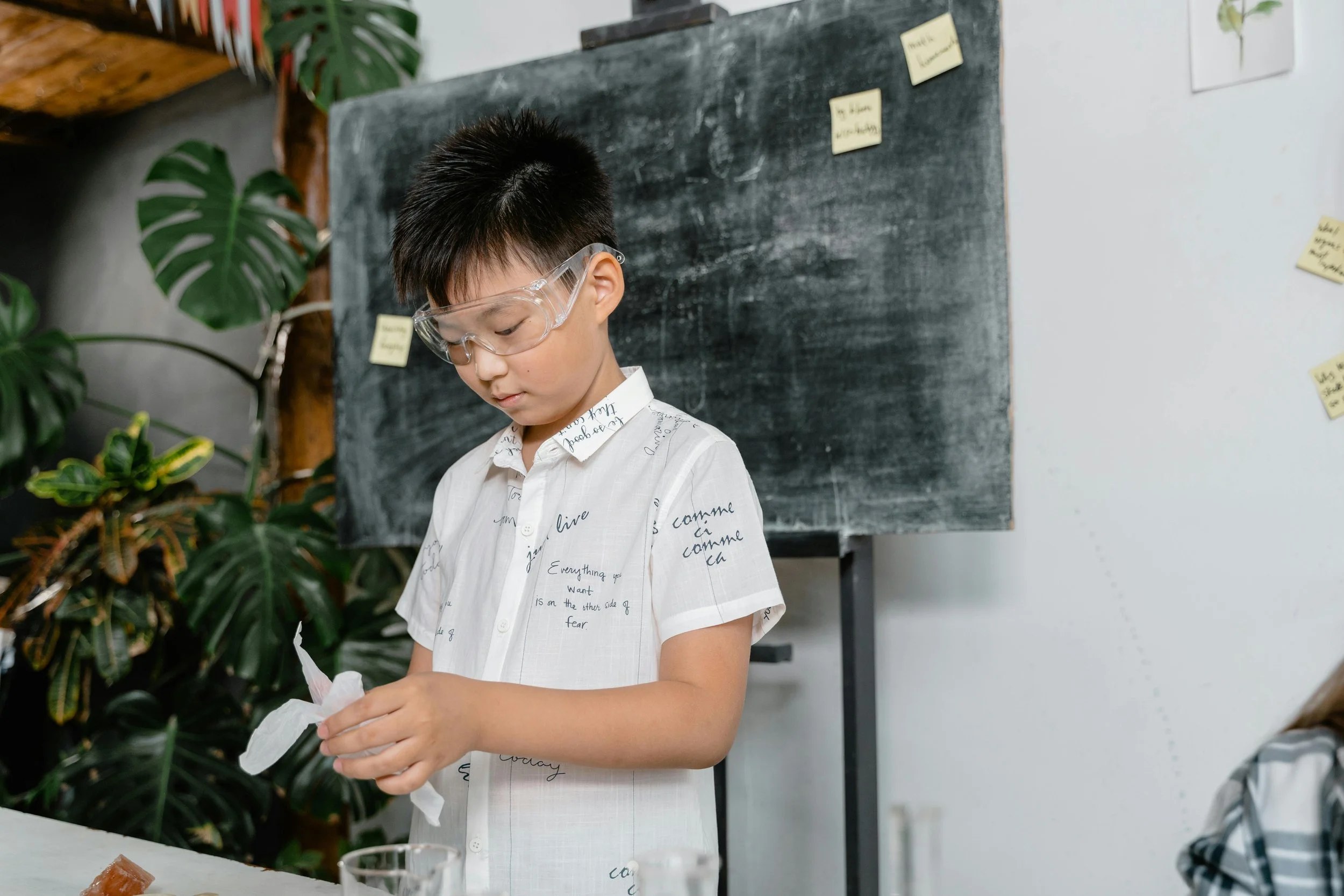 Child presenting in front of blackboard