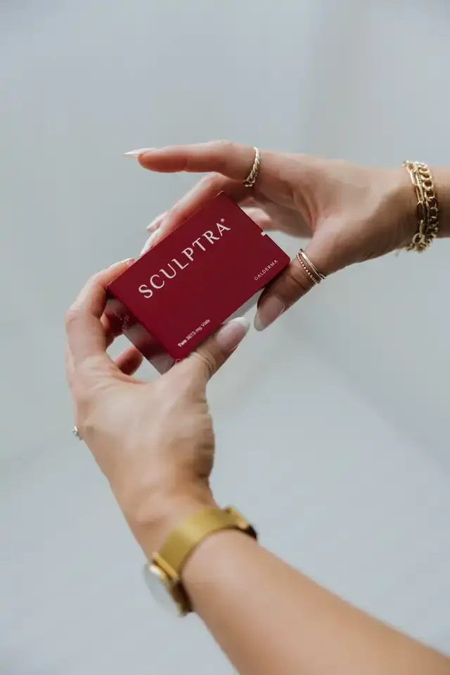 Hands holding a box of Sculptra biostimulator at SKYN in Star, Idaho