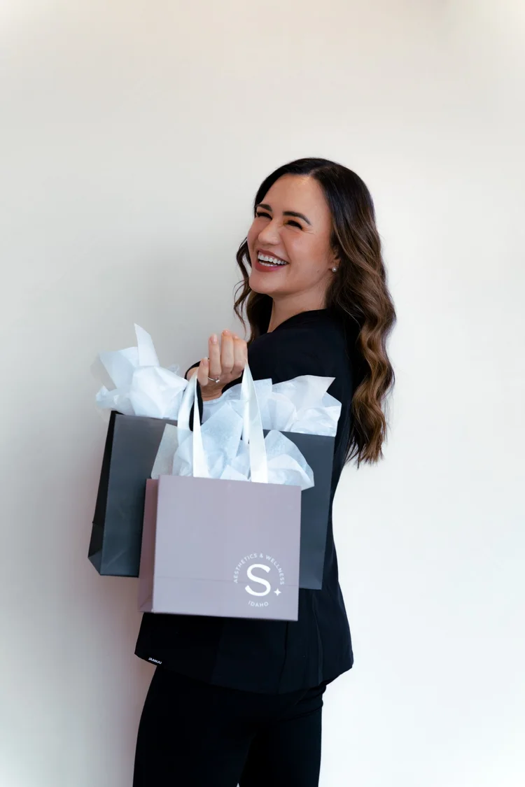 Emily Selkirk with SKYN shopping bags in the Star, Idaho studio
