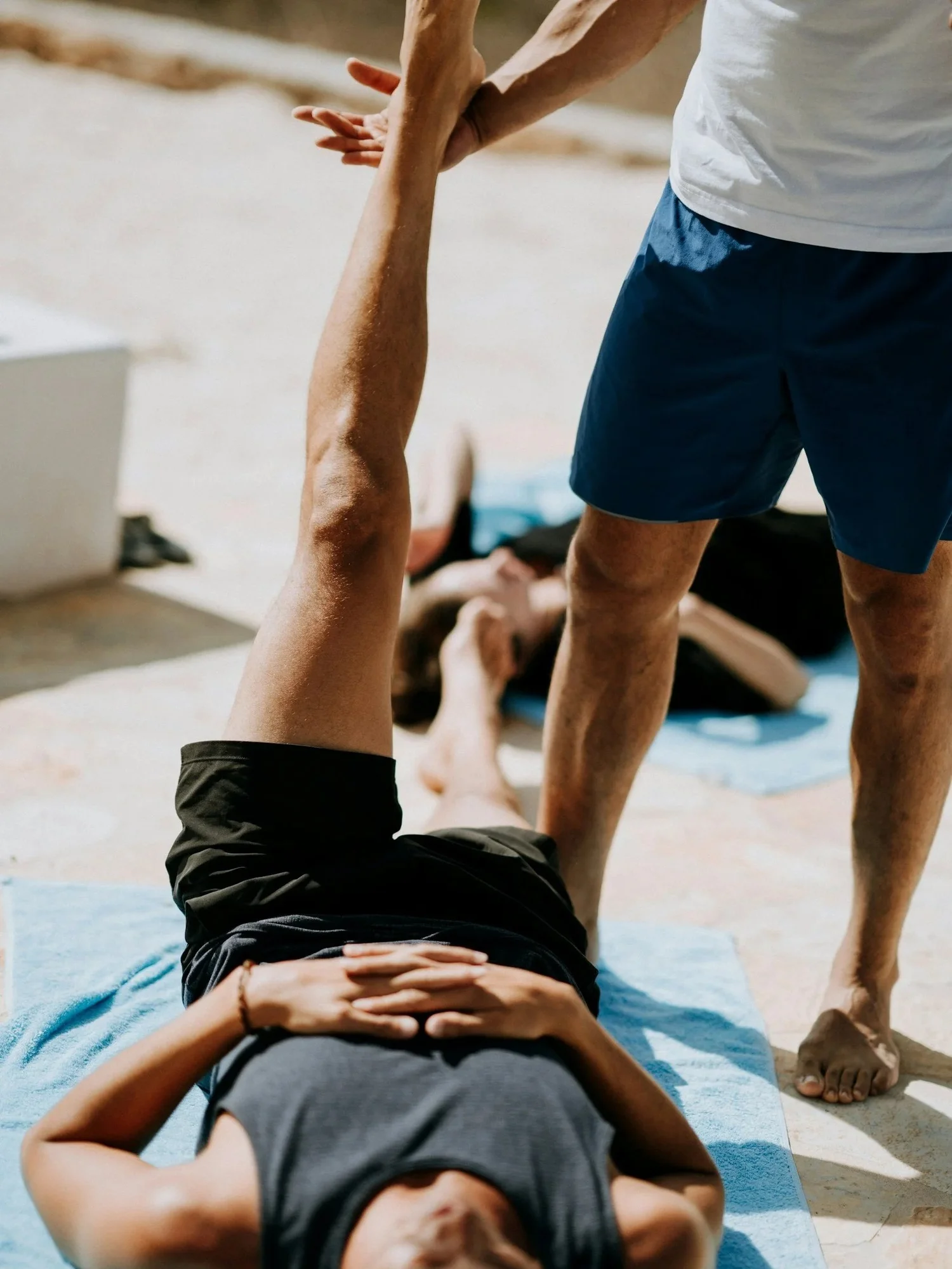Assisted hamstring stretch during a sports rehab session