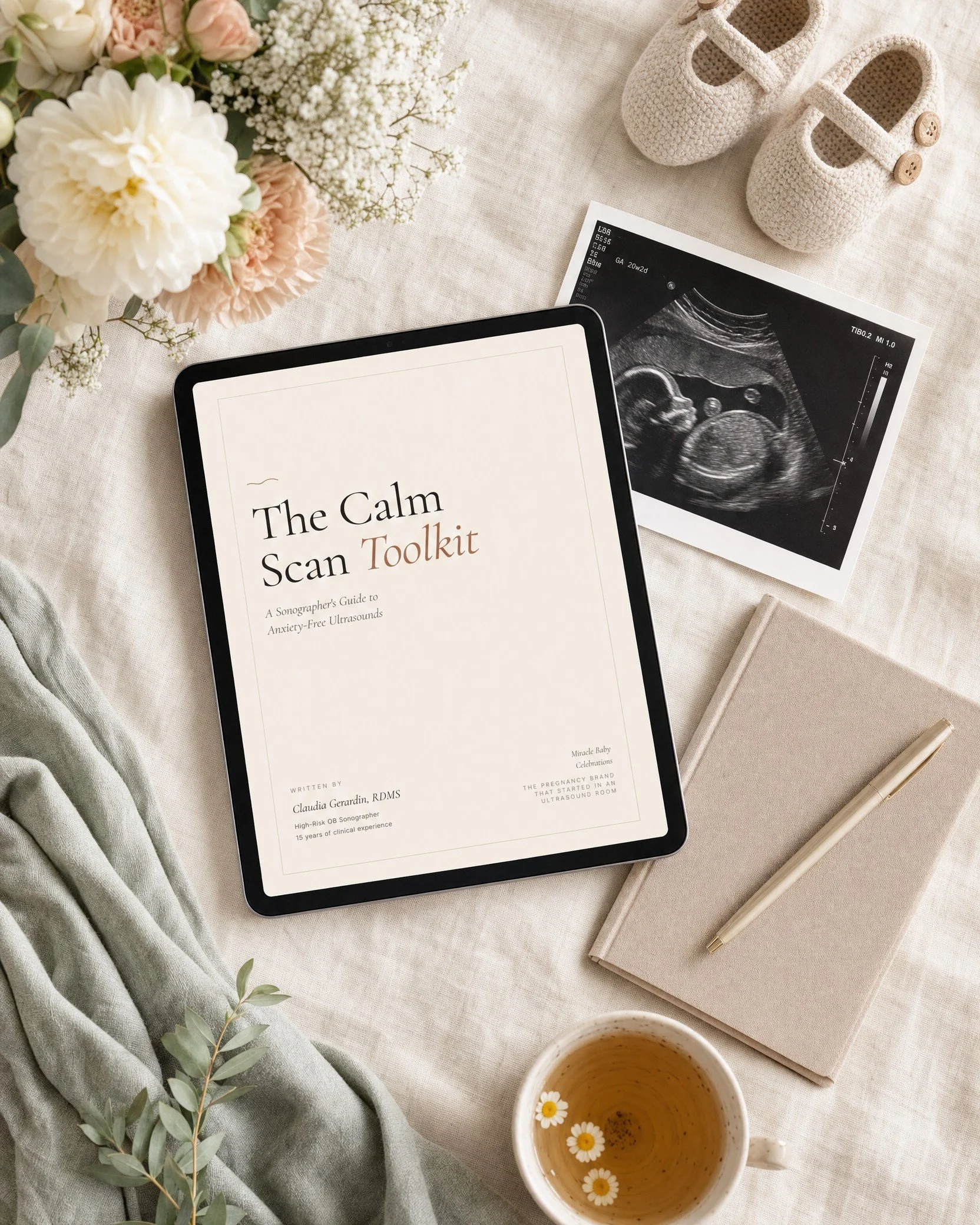 The Calm Scan Toolkit pregnancy ultrasound guide styled flat lay with flowers